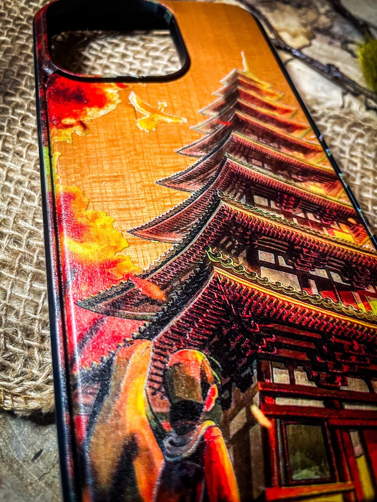 a phone case with a picture of a man and a pagoda on it