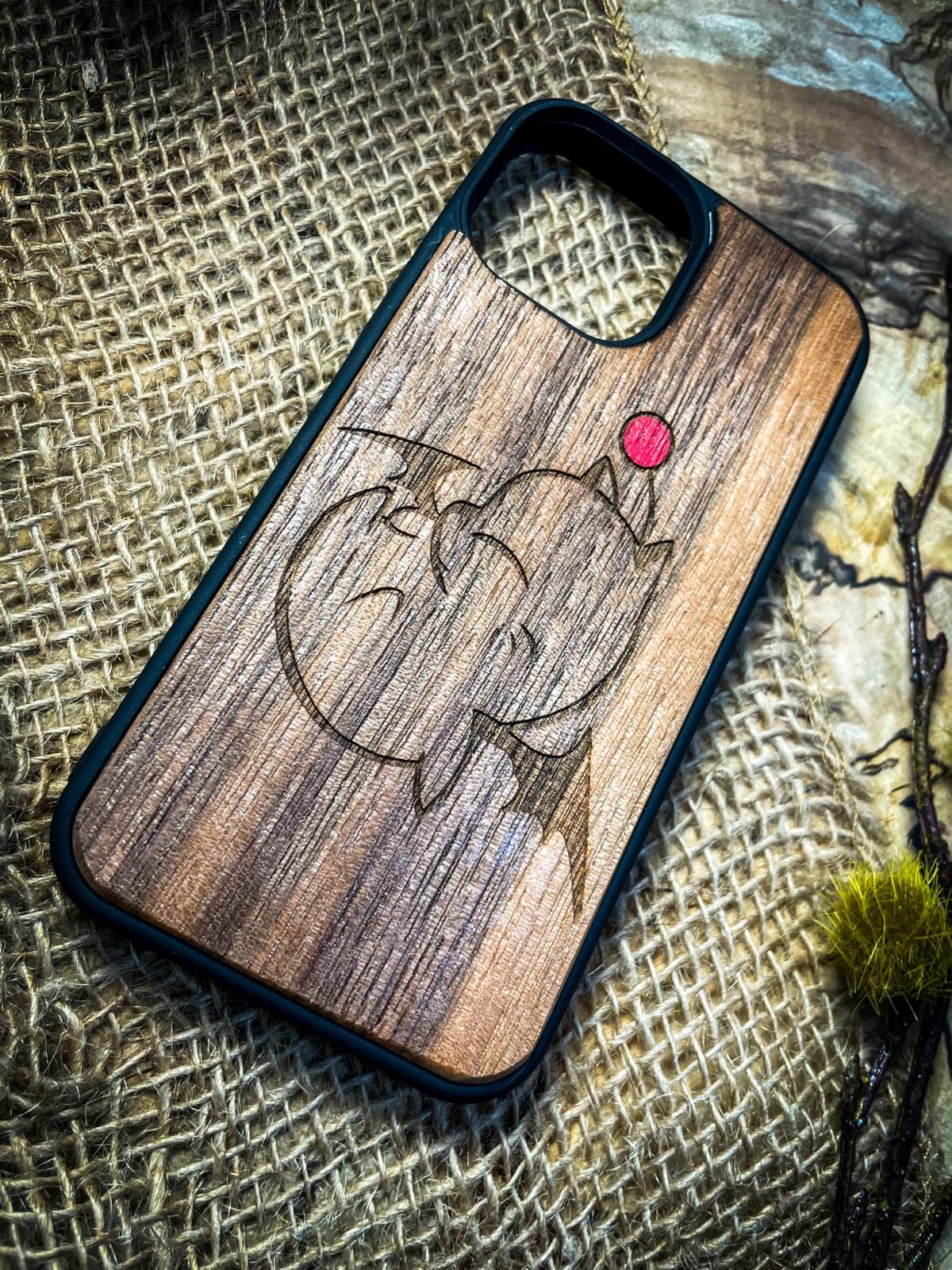 a wooden phone case with a picture of a fish on it