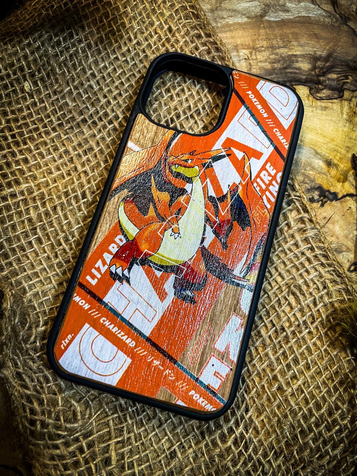 a cell phone case sitting on top of a piece of wood