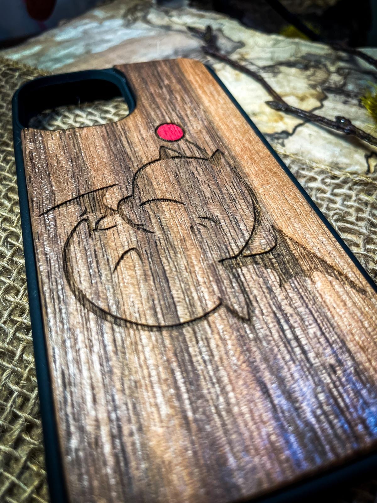 a wooden phone case with a picture of a fish on it