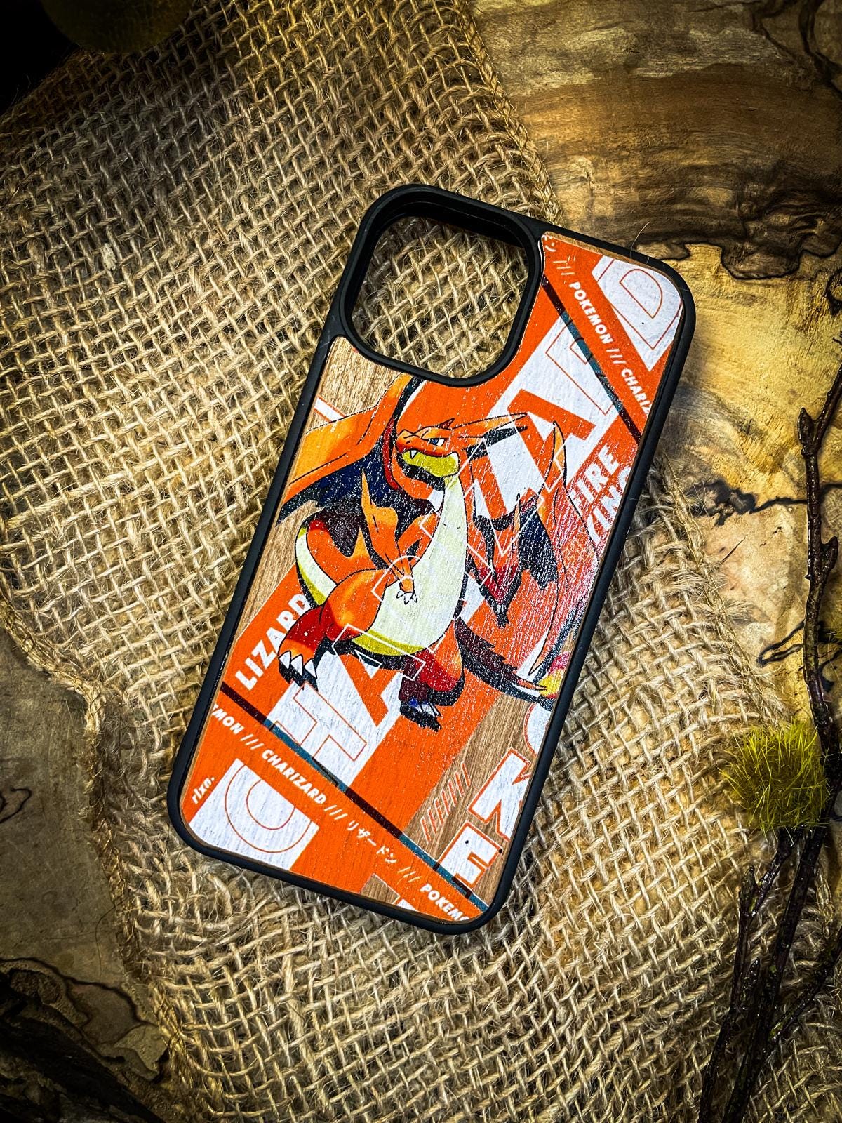 a cell phone case sitting on top of a piece of wood