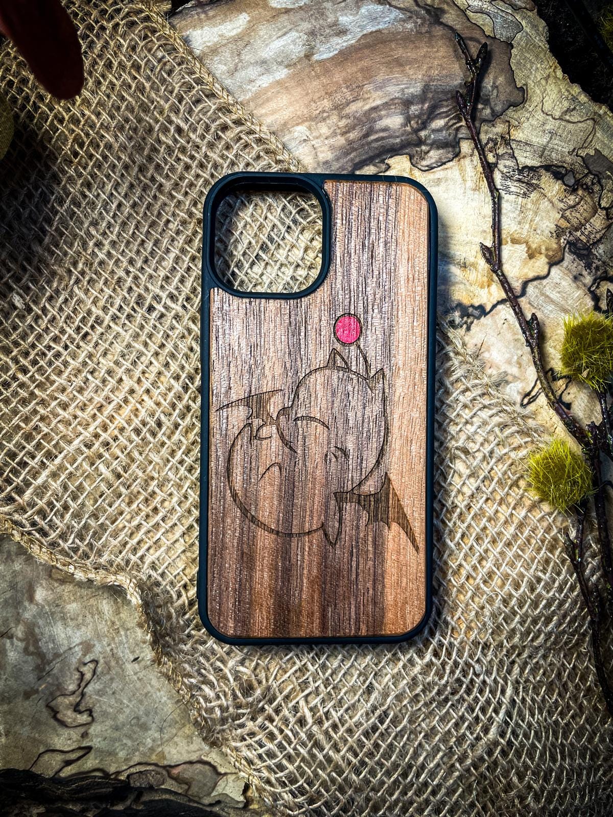 a wooden phone case with a picture of a fish on it