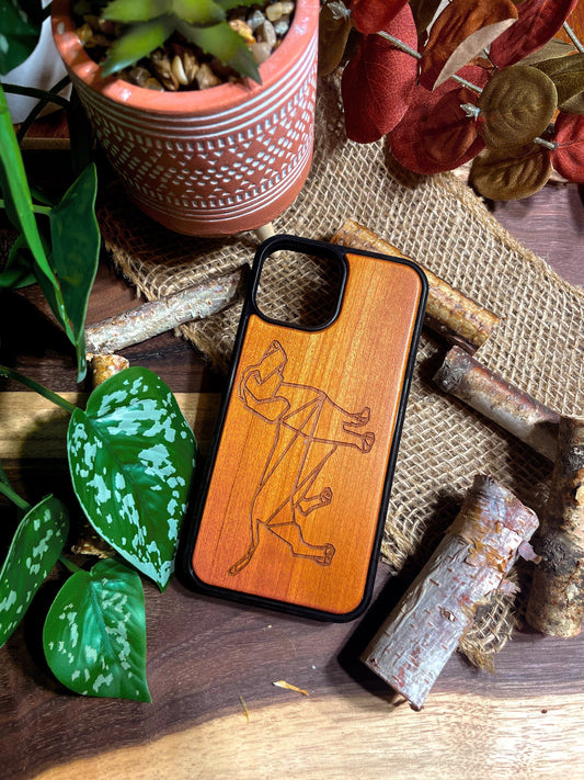 a bunch of wooden phone cases that are on a table