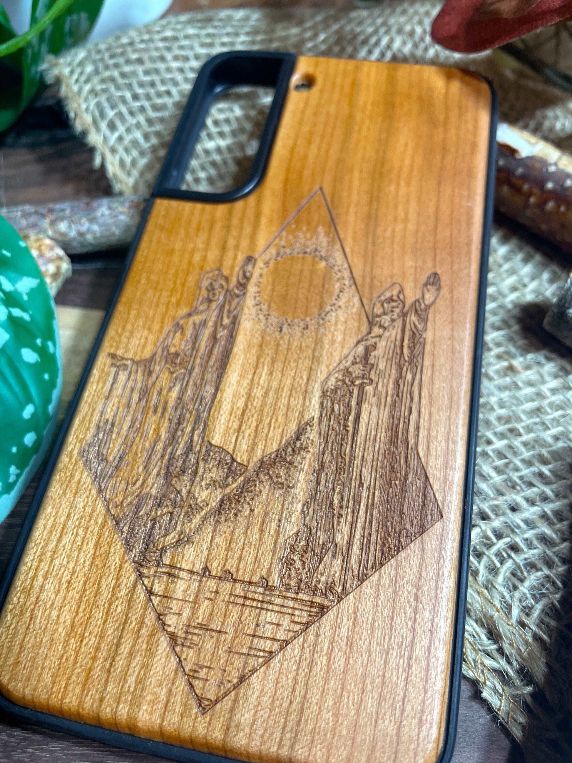 a bunch of wooden phone cases that are on a table