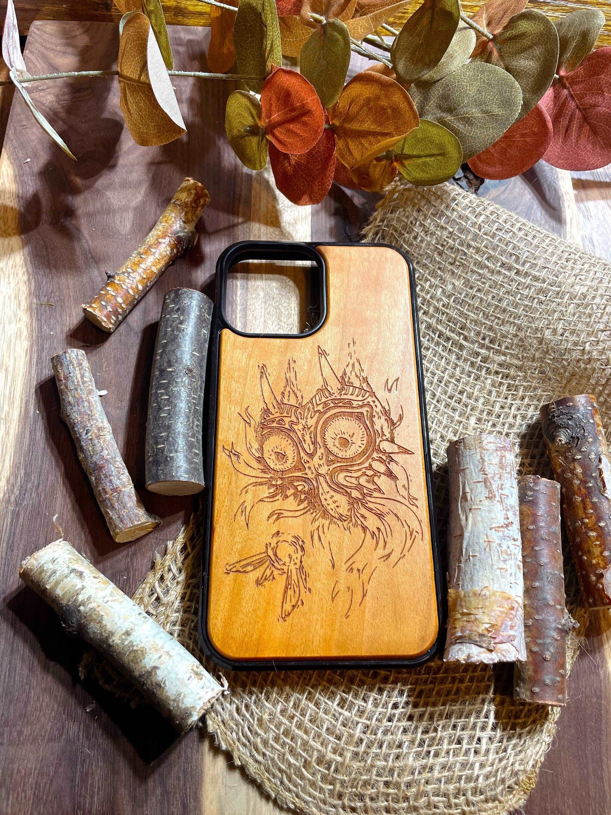 a wooden phone case sitting on top of a wooden table