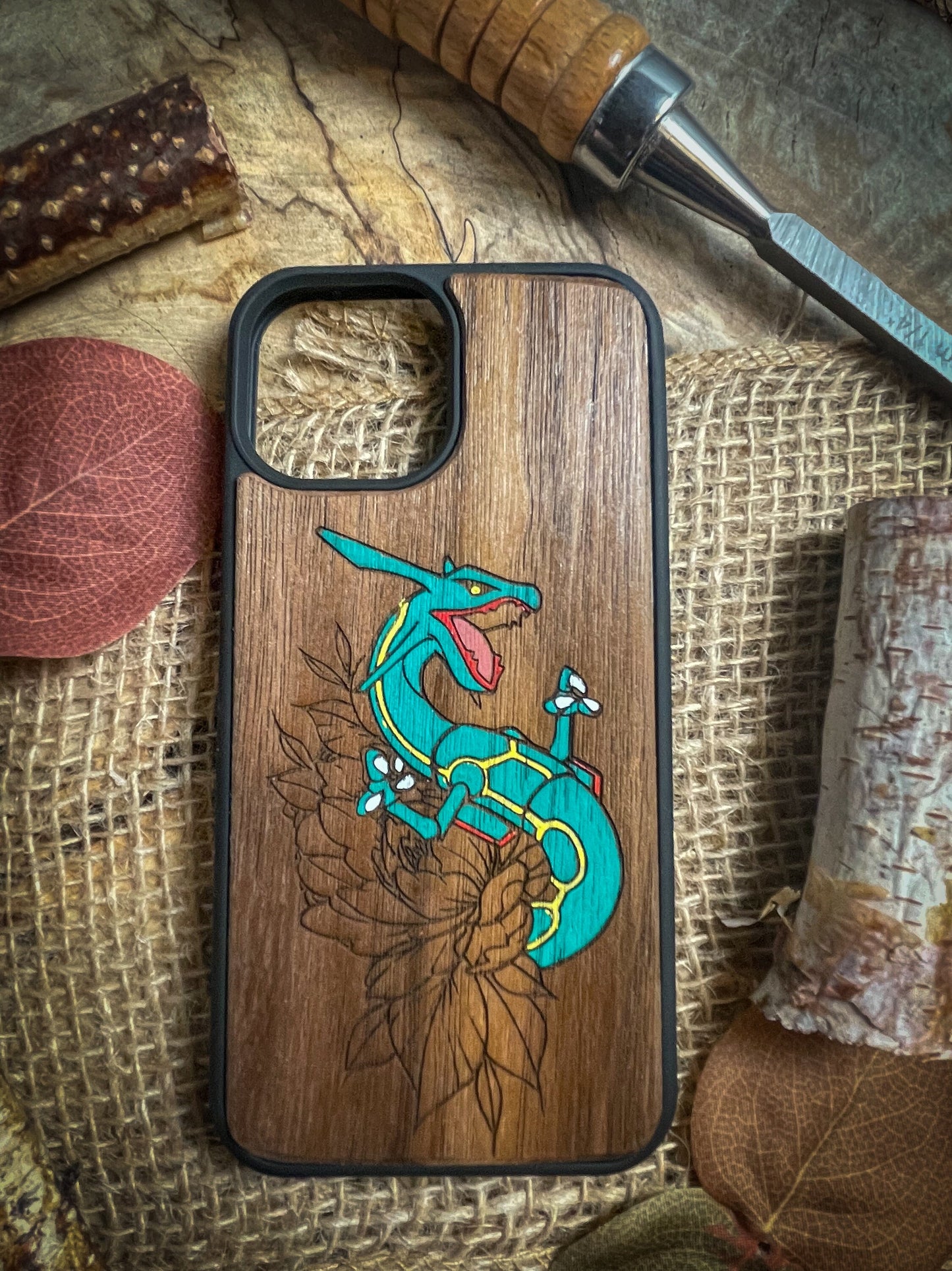 a wooden phone case with a lizard on it