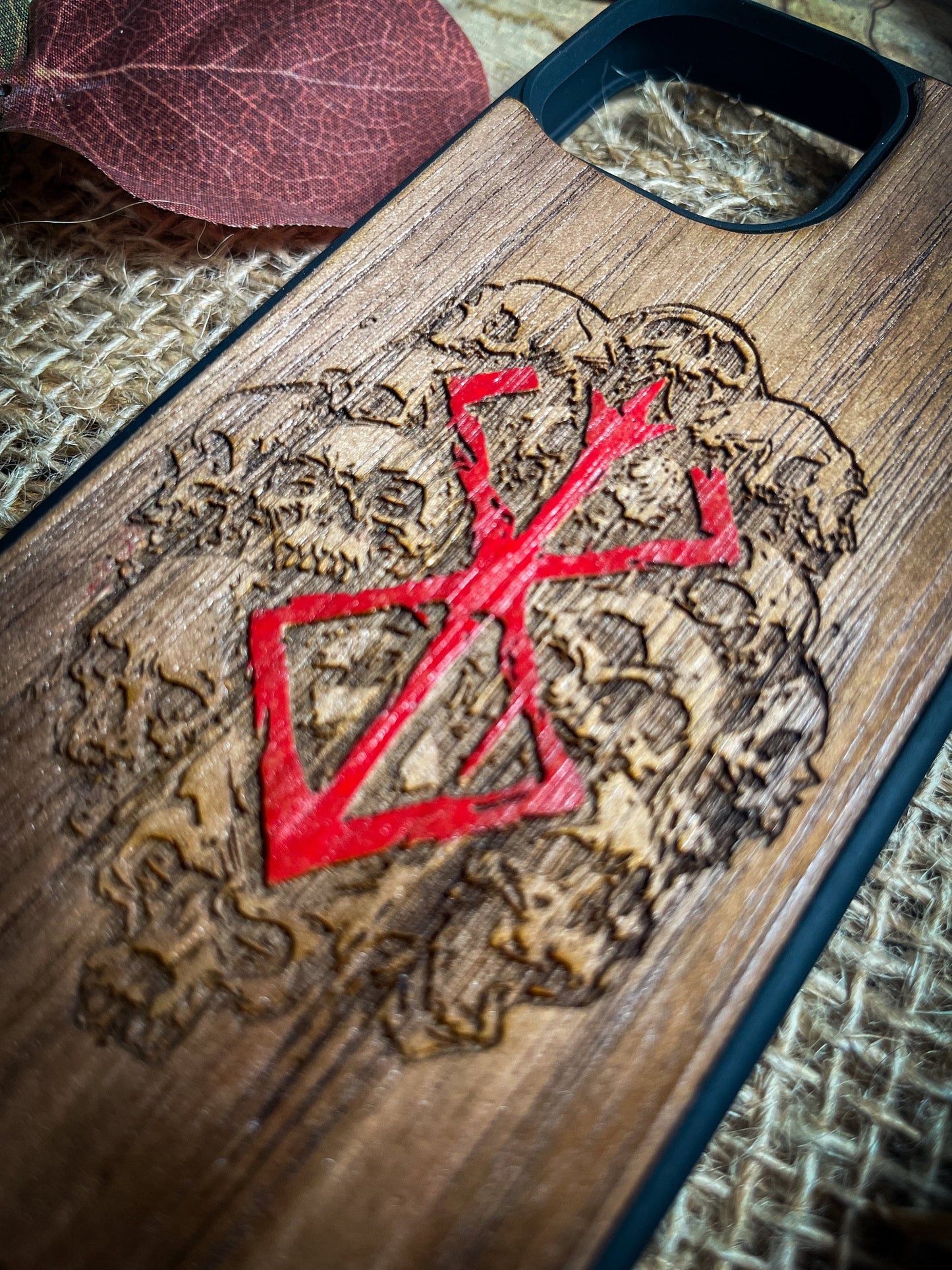 a wooden case with a red design on it