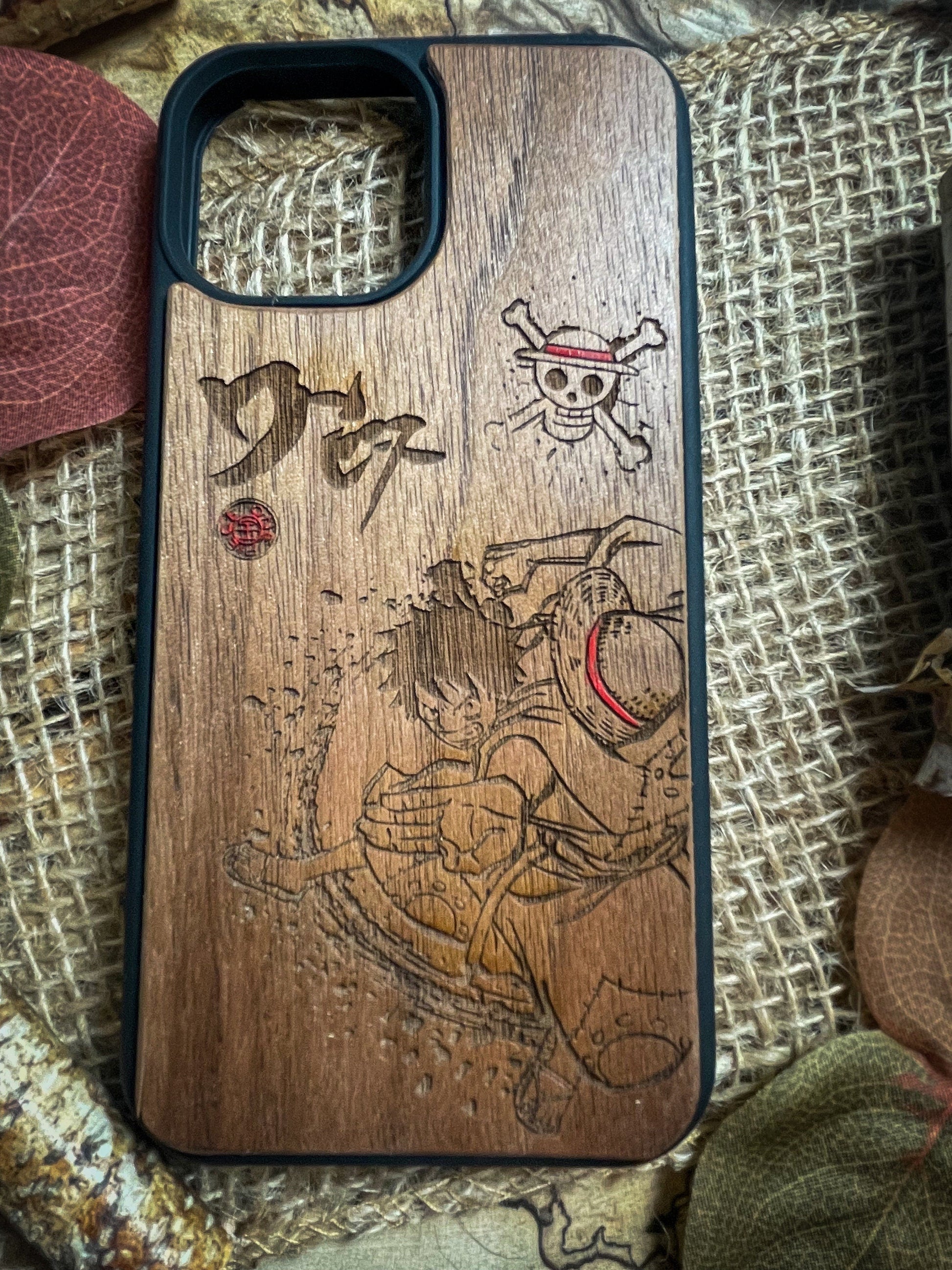 a wooden phone case with a pirate scene on it