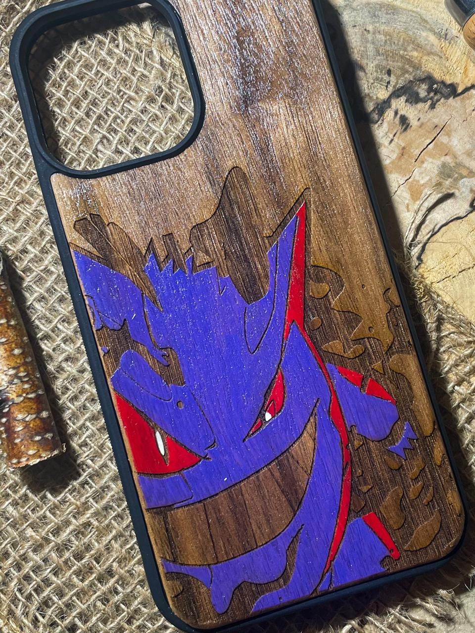 a wooden phone case with a picture of a dragon on it