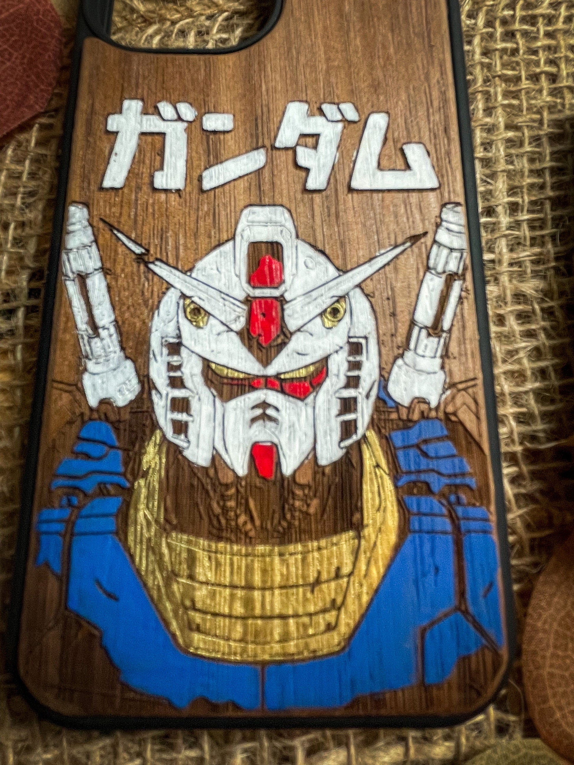 a wooden phone case with a picture of a robot on it