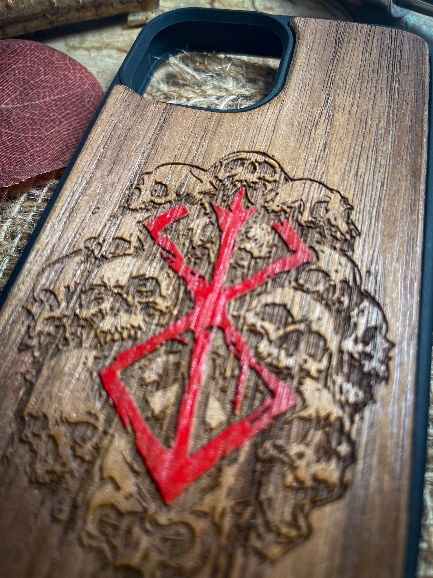 a wooden case with a red design on it