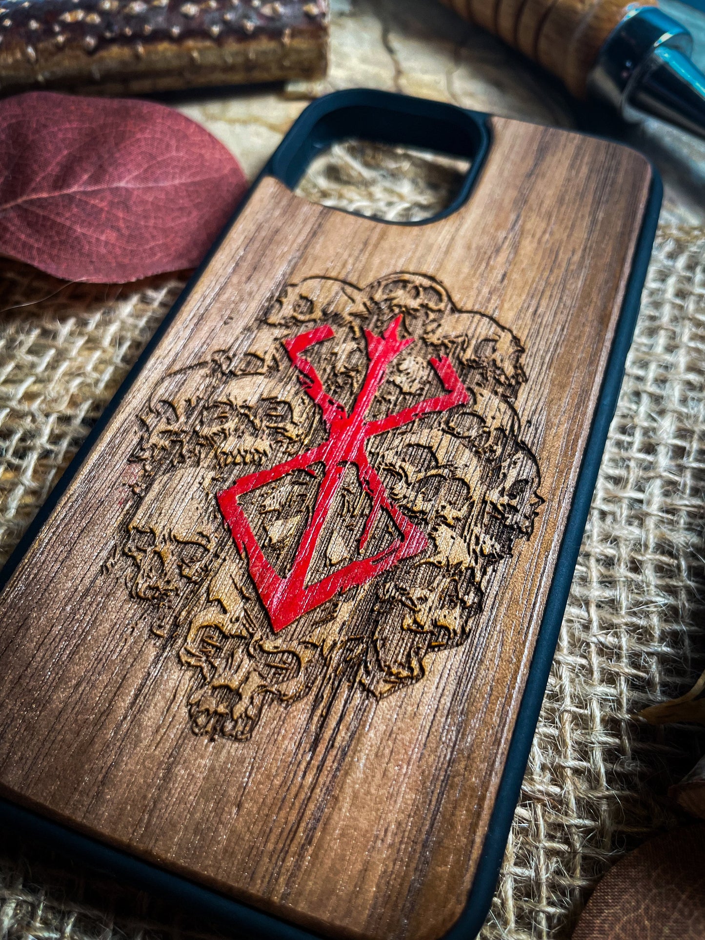 a wooden phone case with a red cross on it