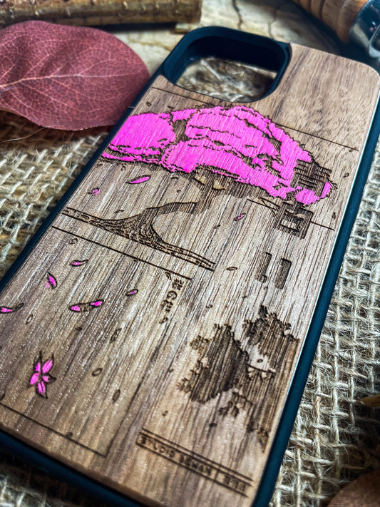 a wooden phone case with a picture of a tree