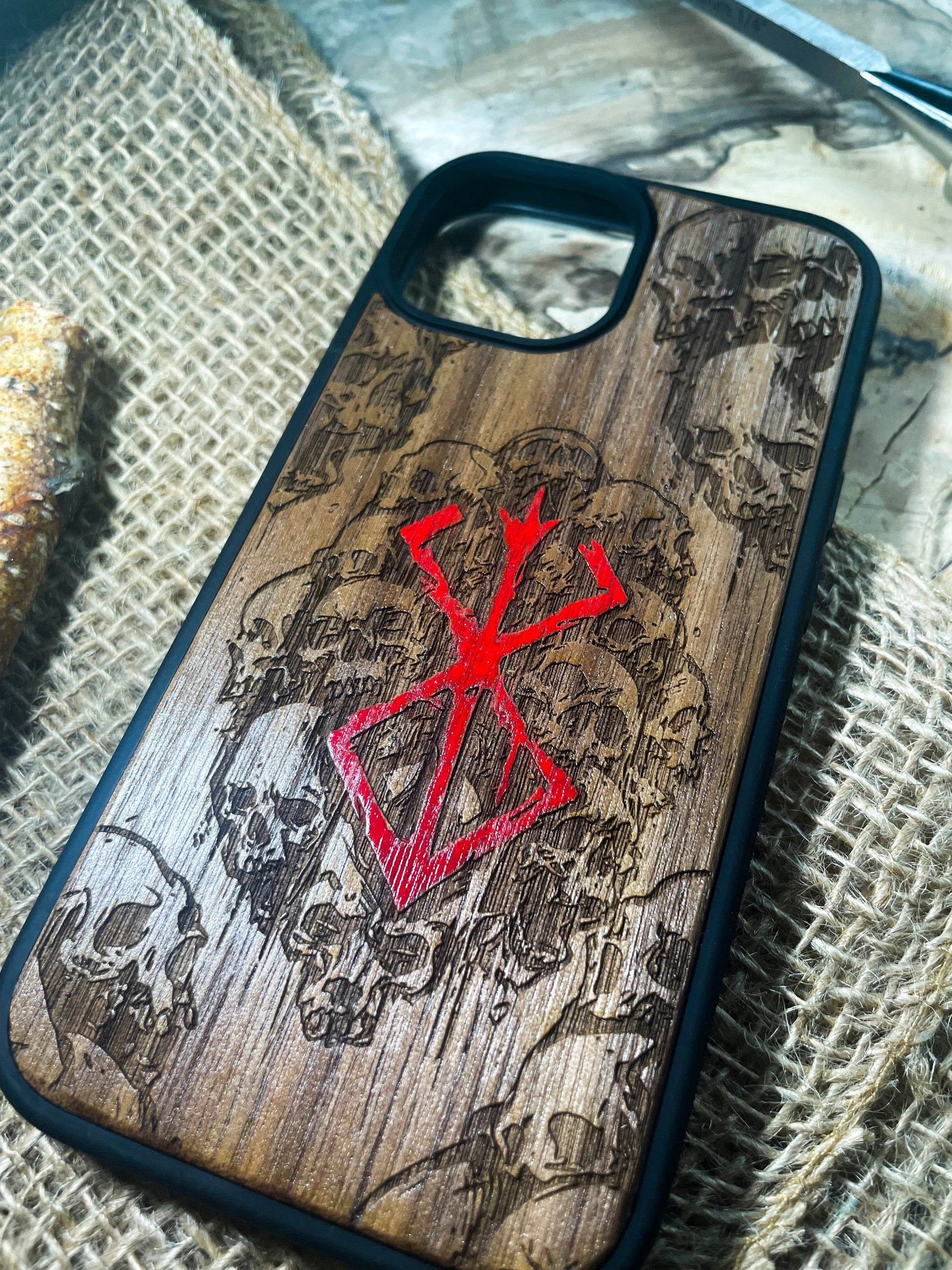 a wooden phone case with a red cross on it