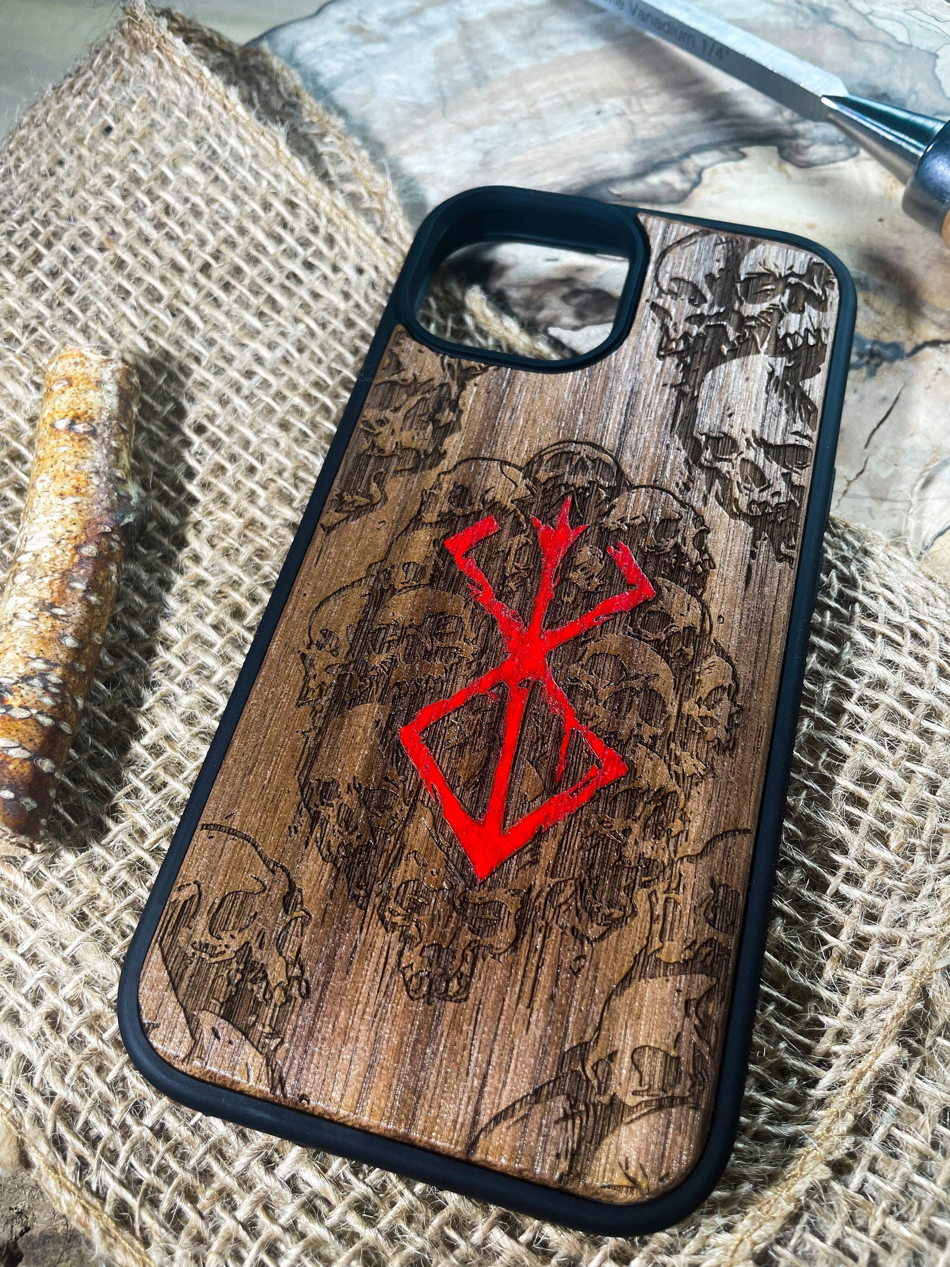 a wooden phone case with a red design on it