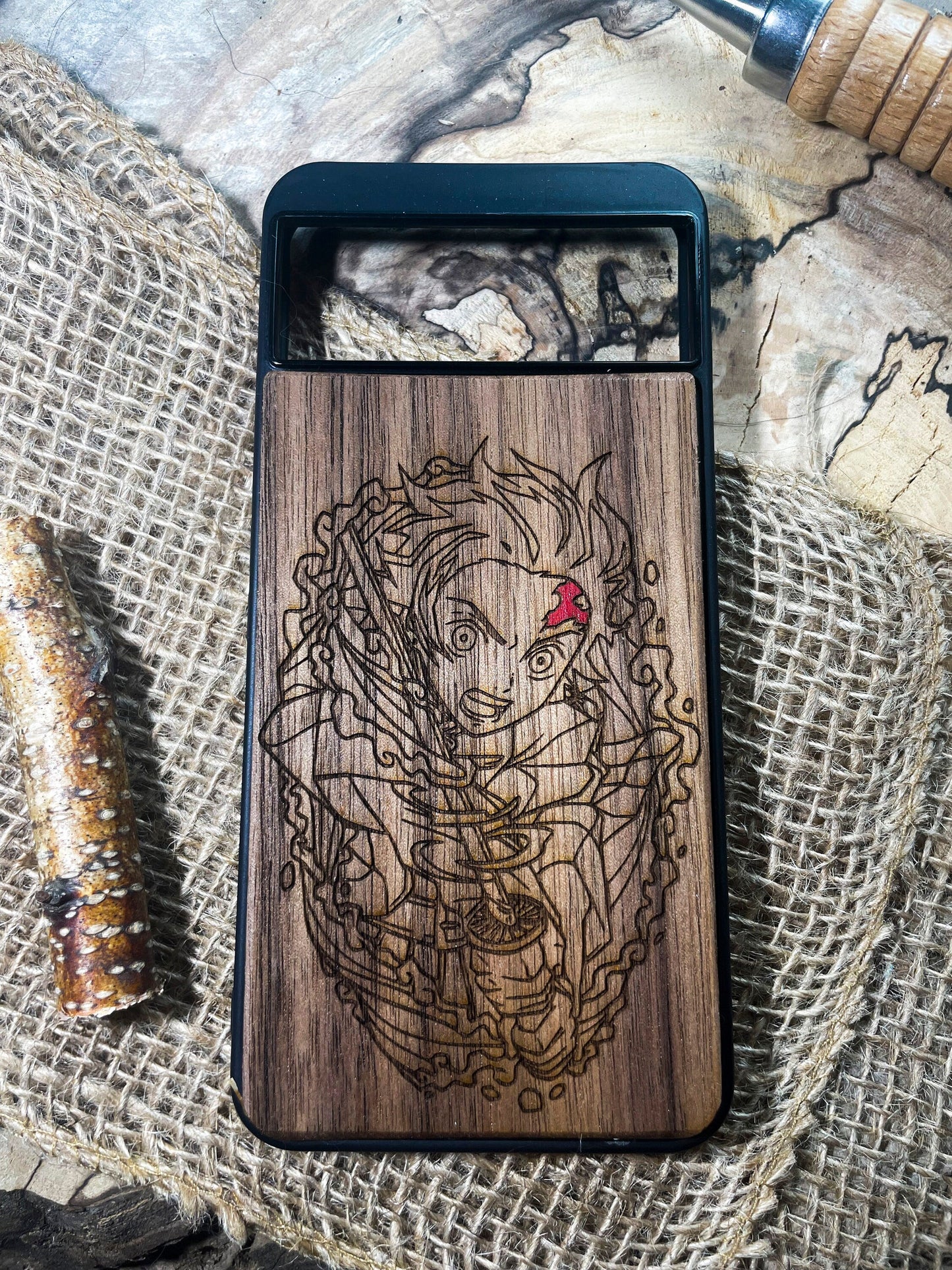 a wooden phone case with a lady bug on it