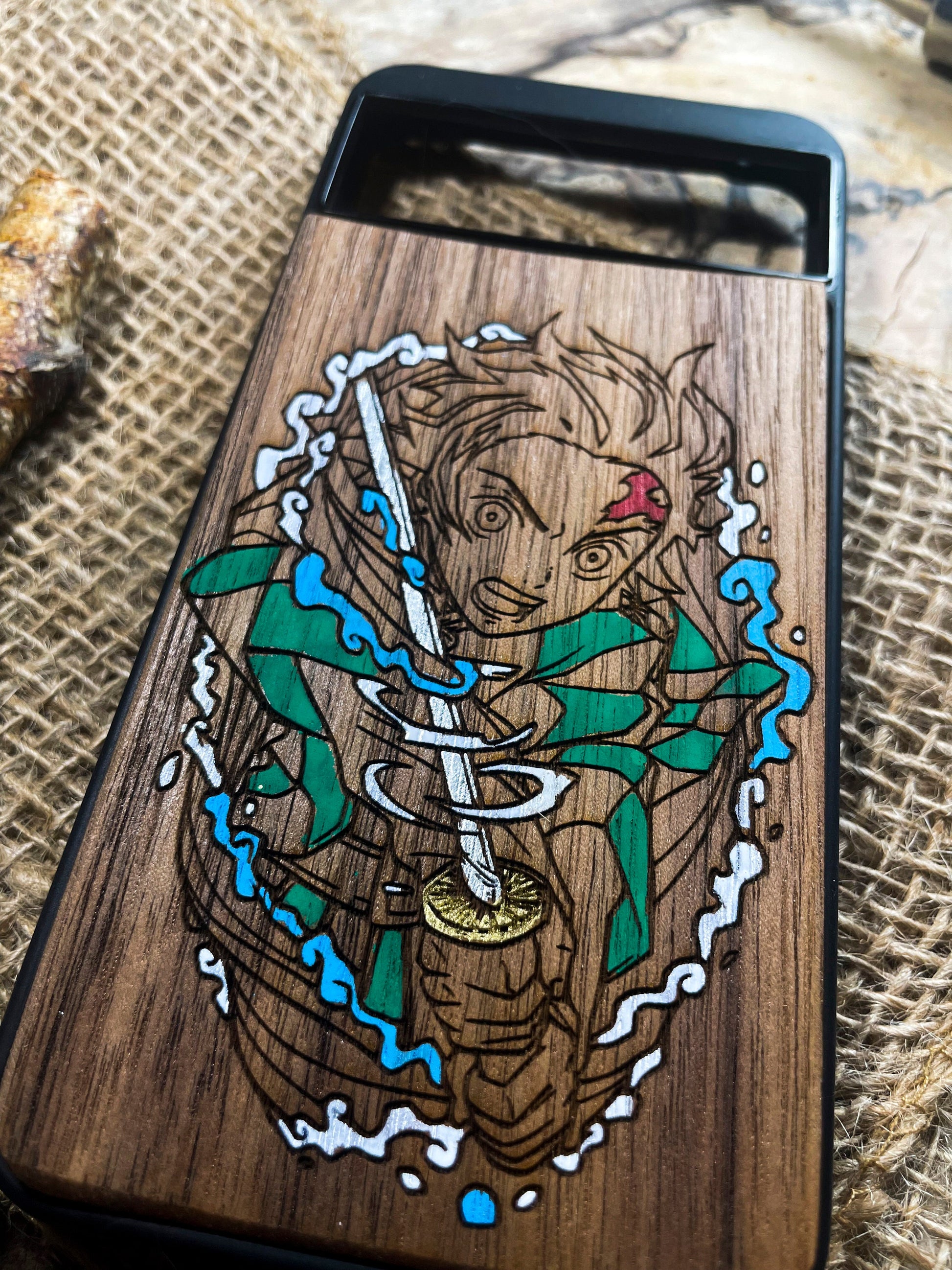 a wooden phone case with a picture of a man holding a sword