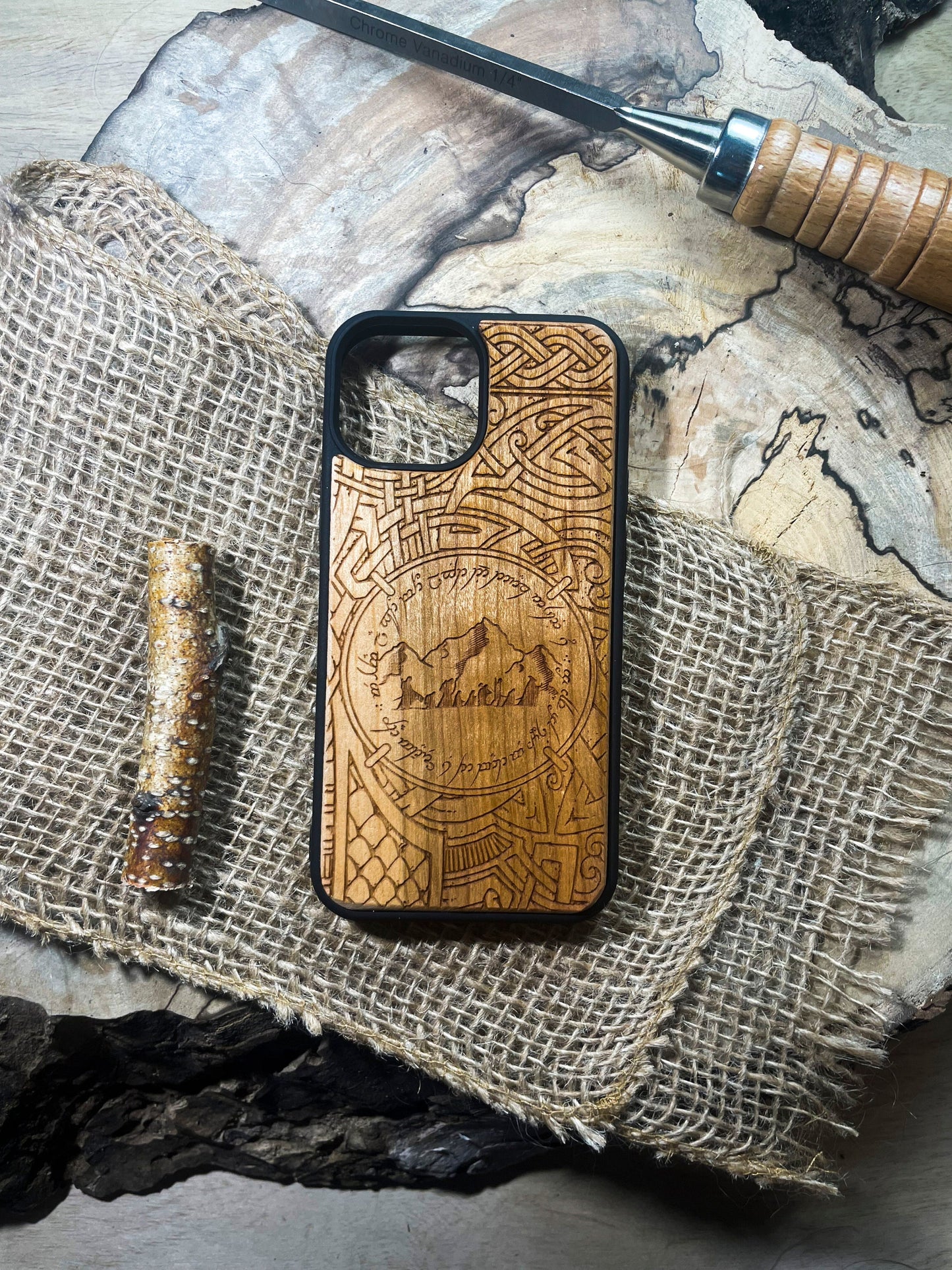 a wooden phone case sitting on top of a piece of wood