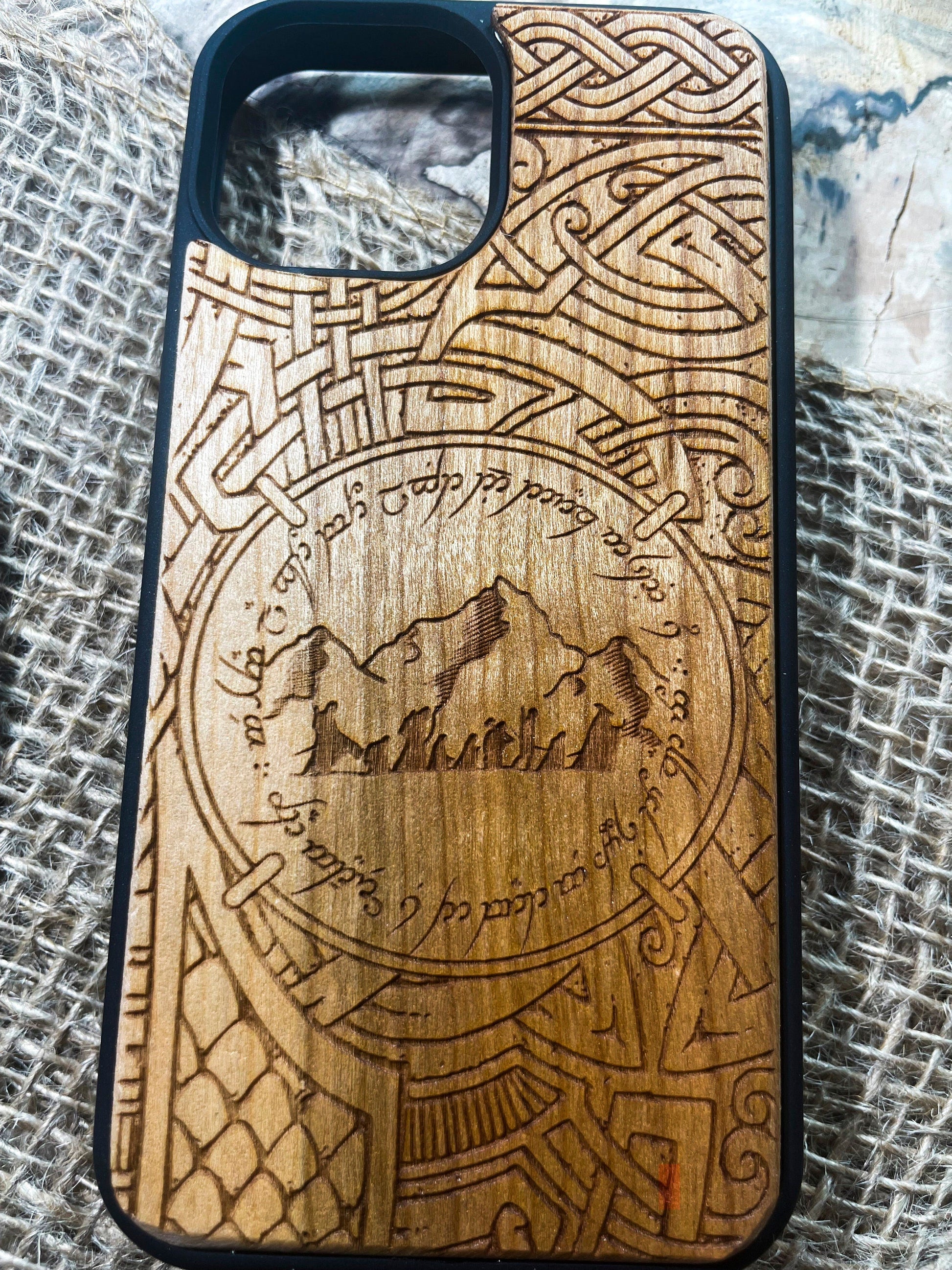 a wooden phone case with a design on it