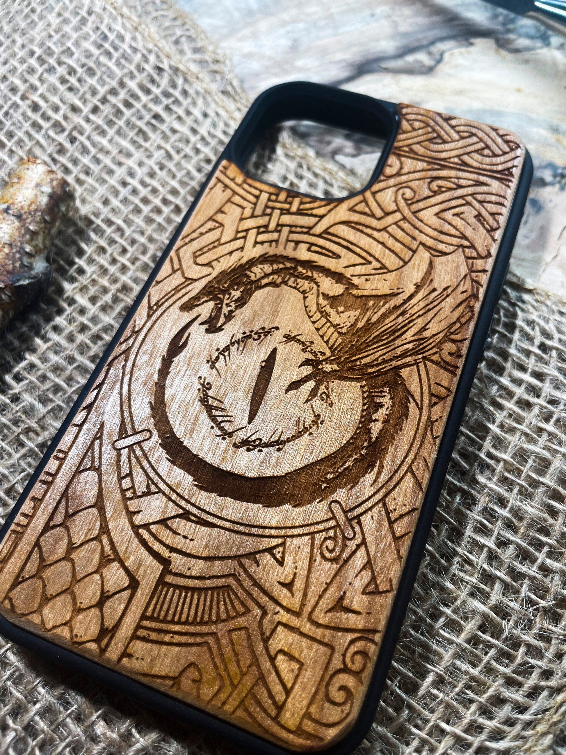 a wooden phone case with a picture of a dragon on it