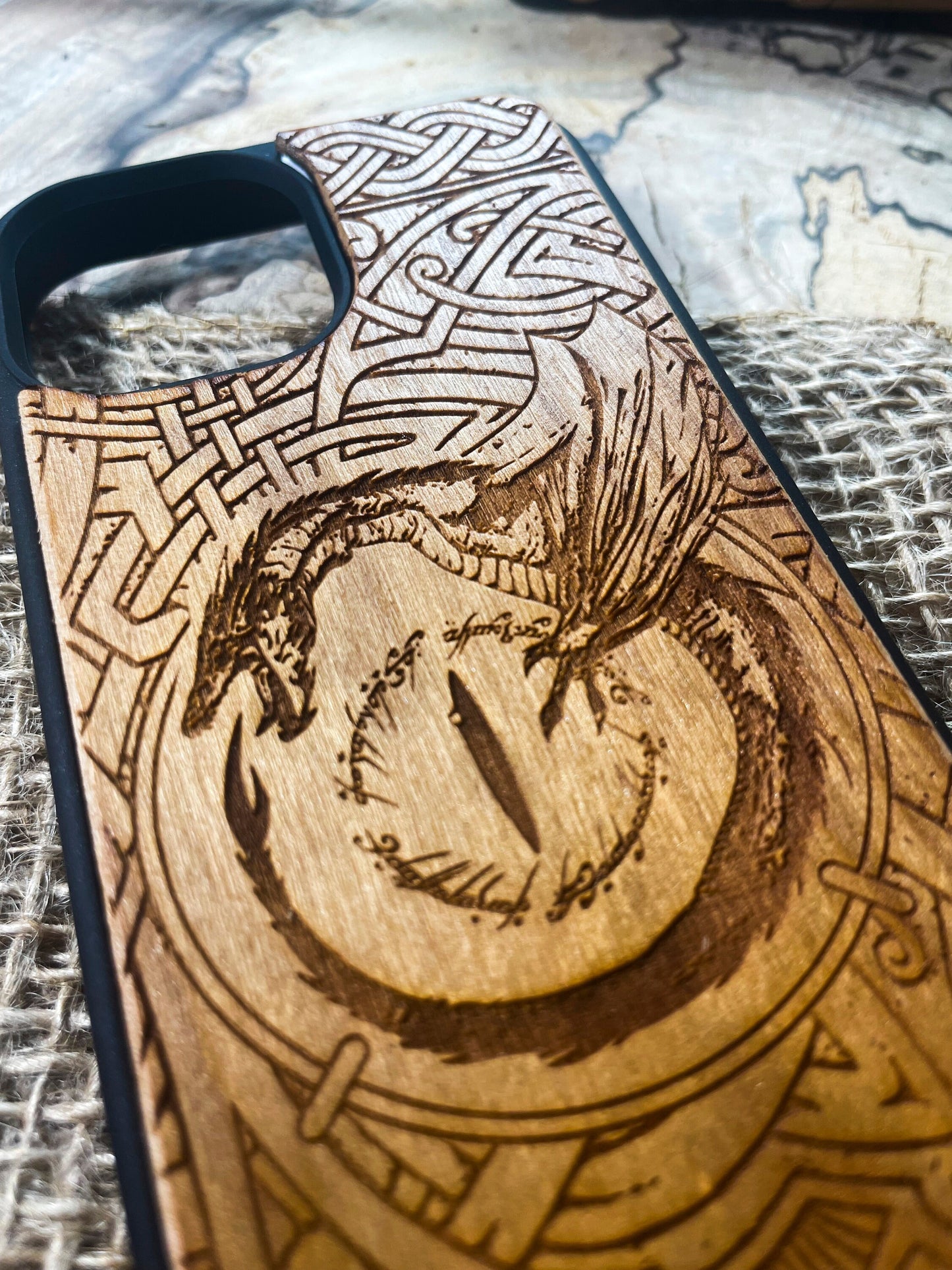 a wooden phone case with a picture of a dragon on it