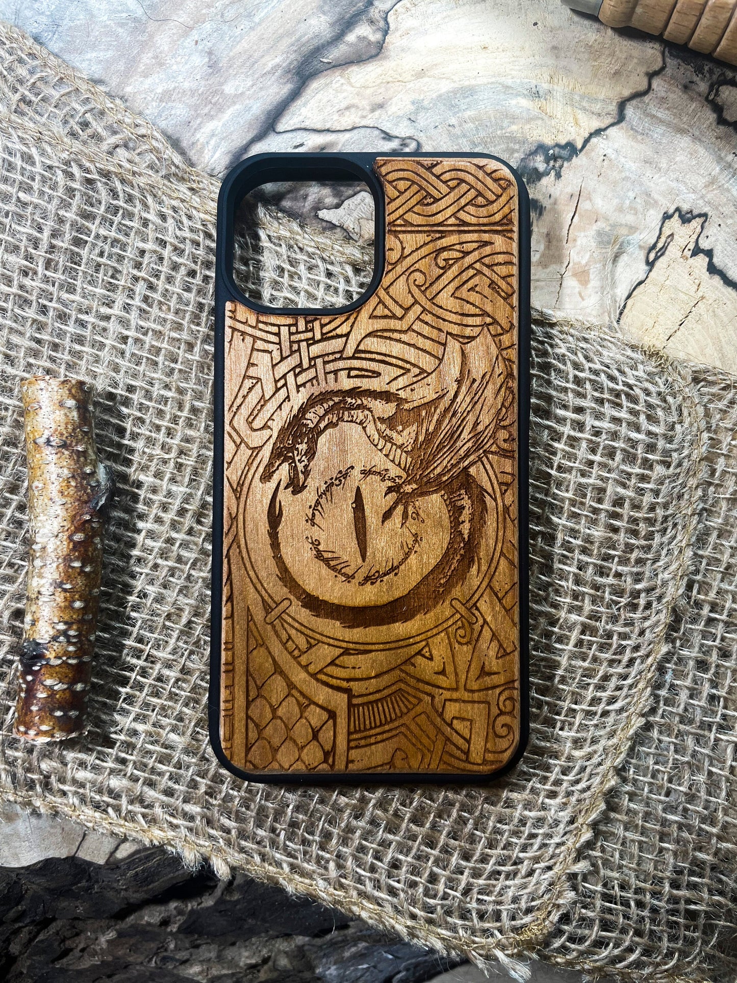 a wooden phone case with a picture of a dragon on it