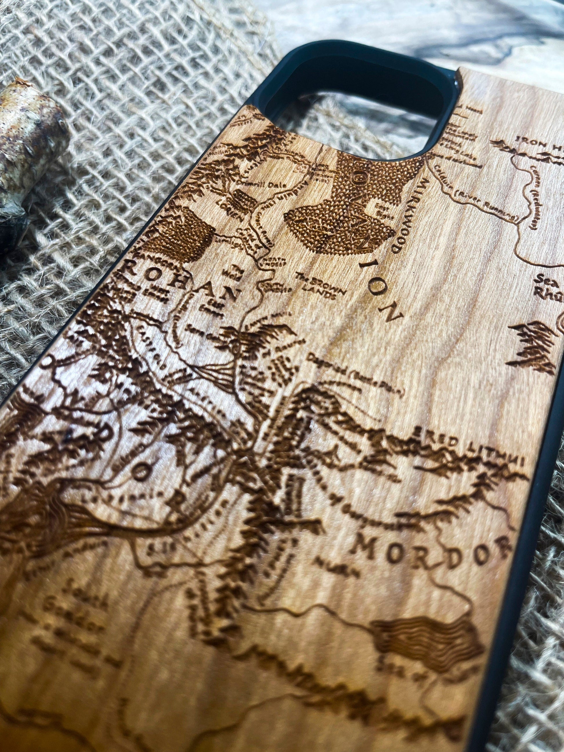 a wooden phone case with a map of the world on it