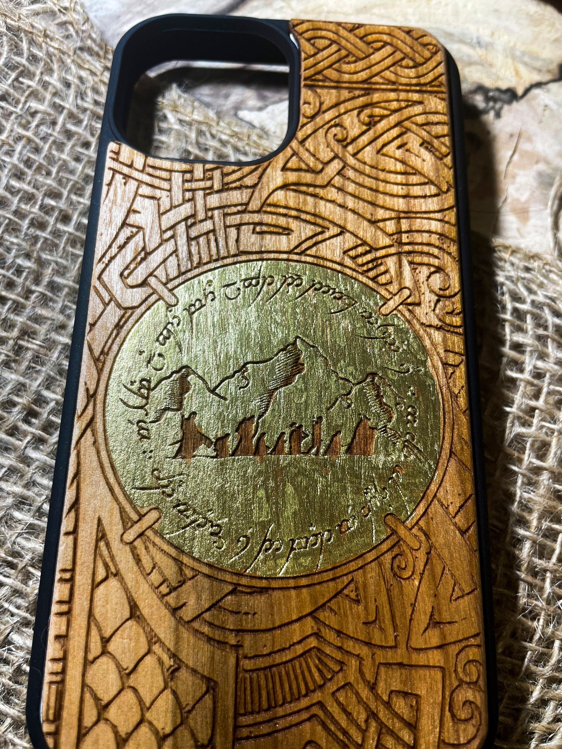 a wooden phone case with a design on it