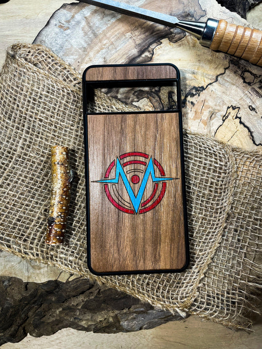 a wooden phone case sitting on top of a piece of wood