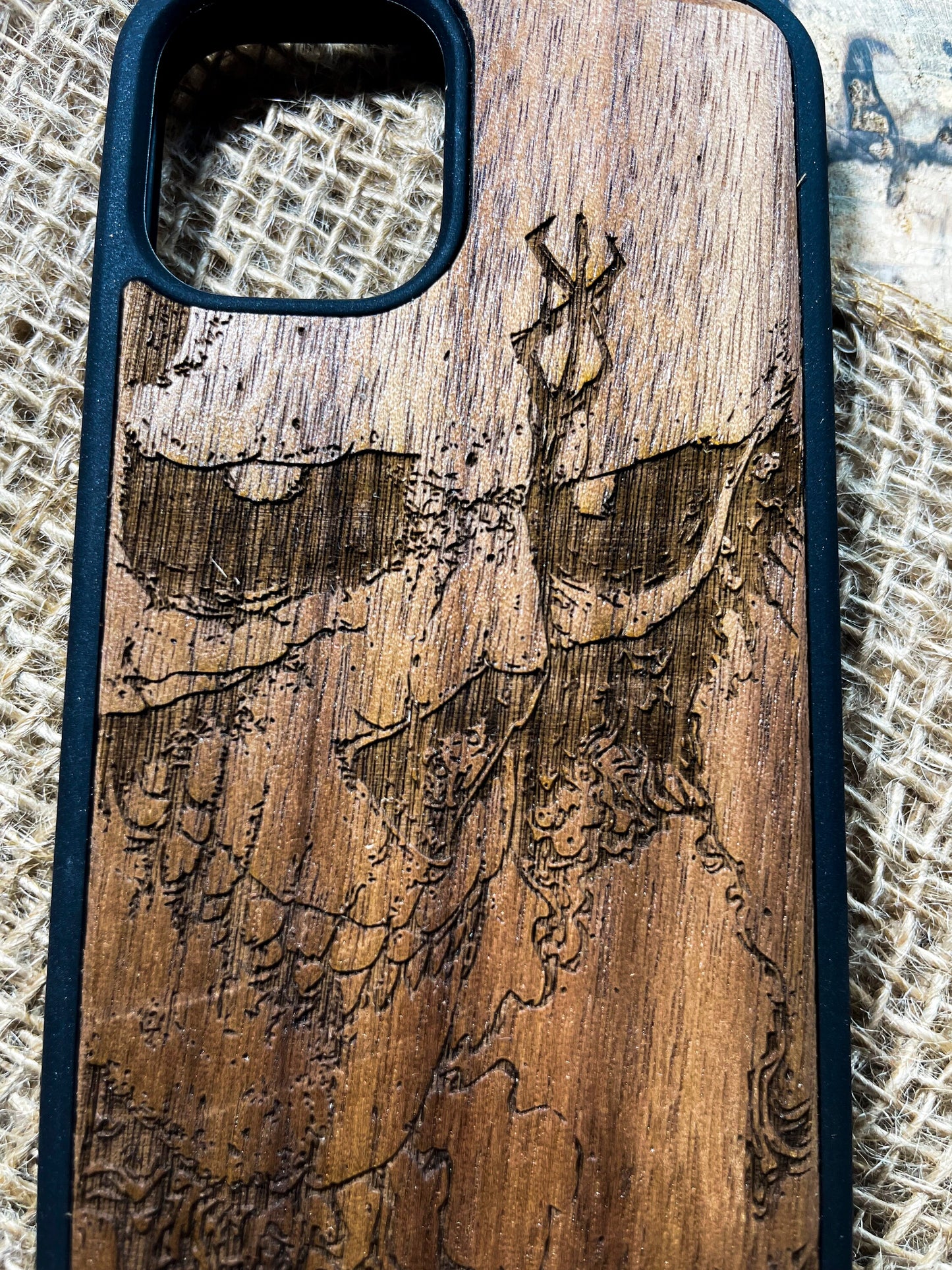 a wooden phone case with a picture of a deer