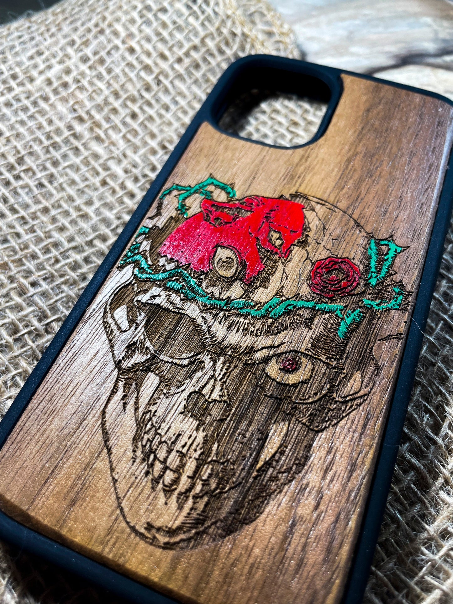 a wooden phone case with a picture of a skull on it