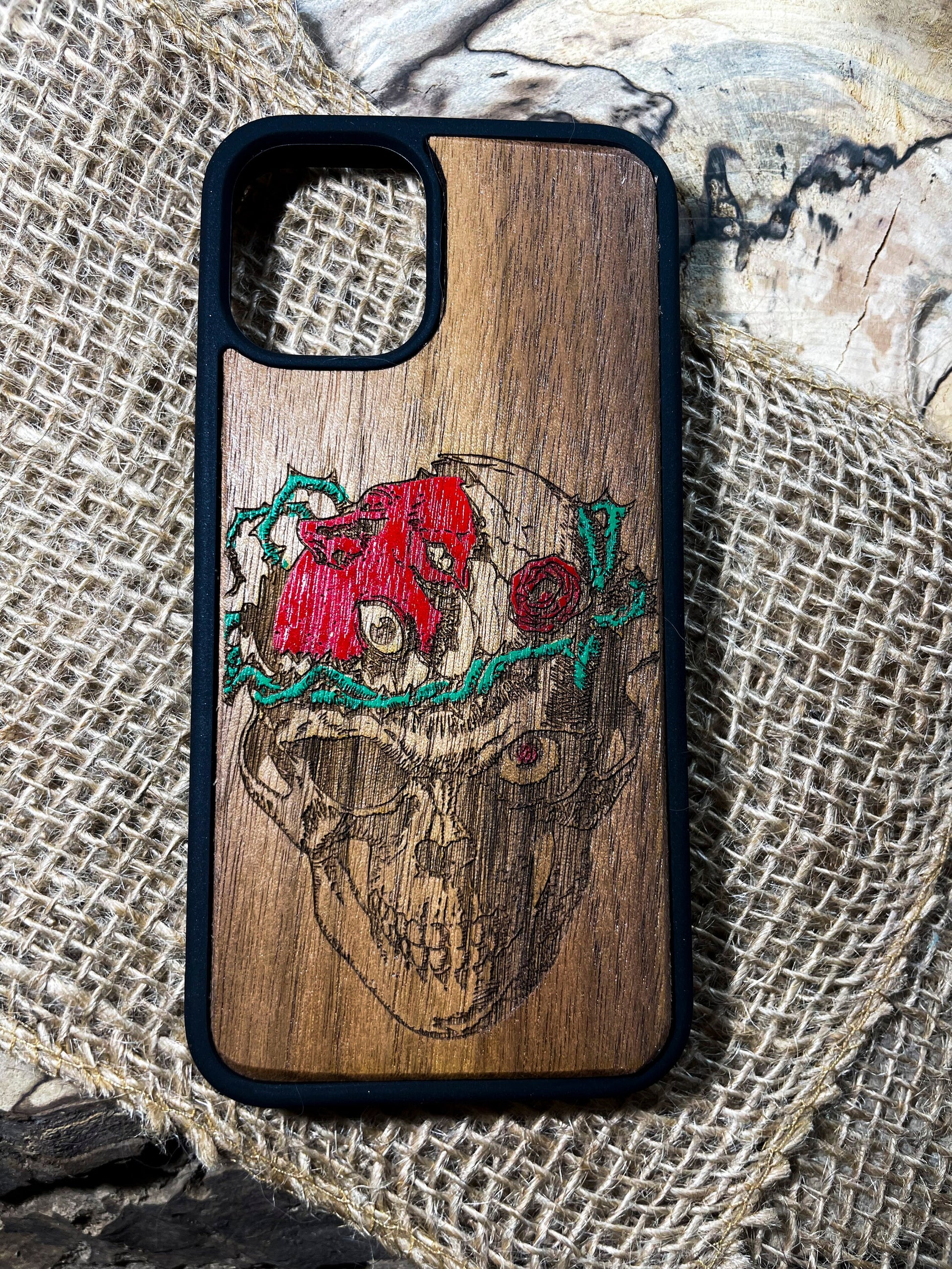 a wooden phone case with a picture of a skull on it