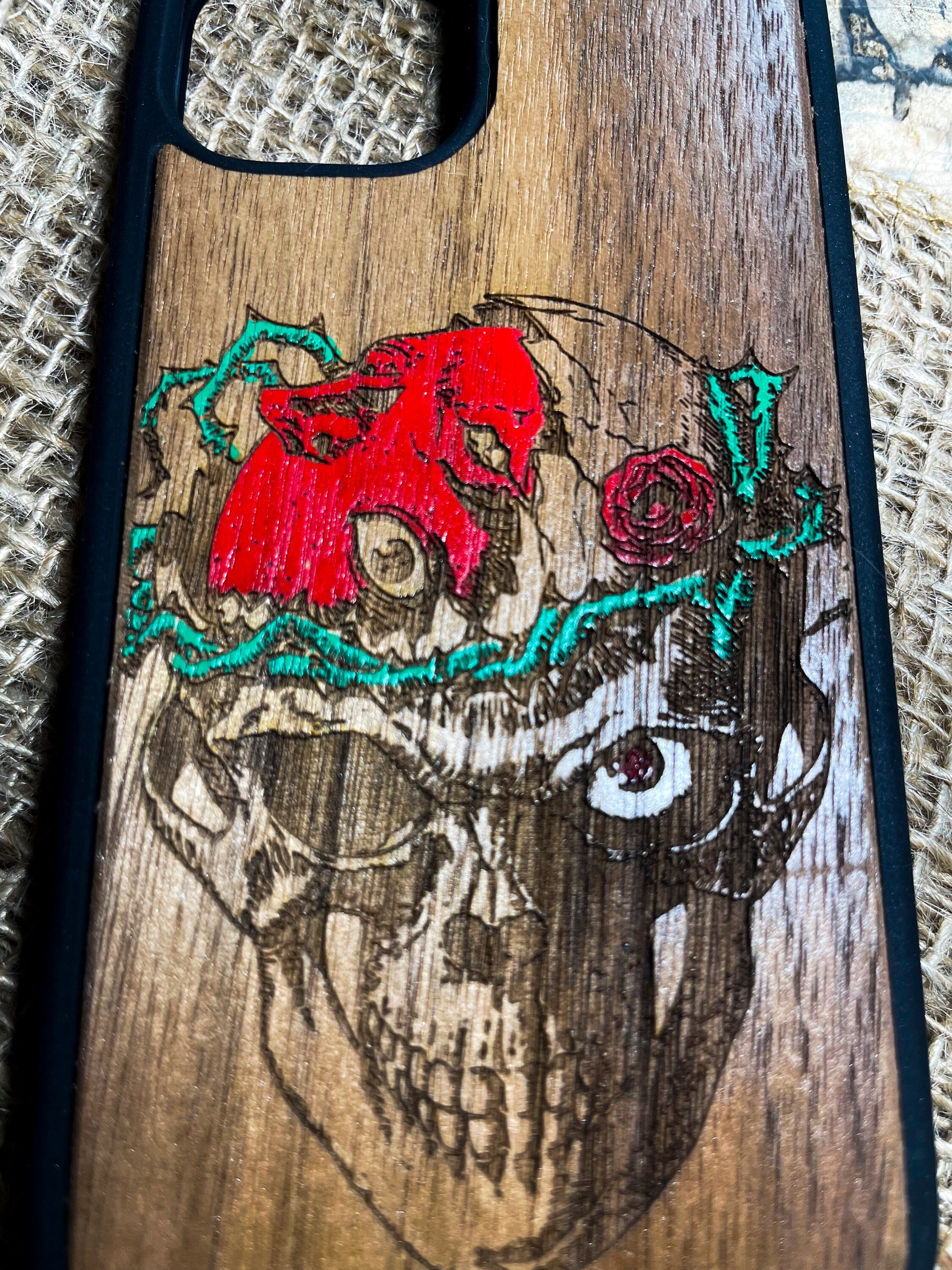 a wooden case with a picture of a skull and roses on it