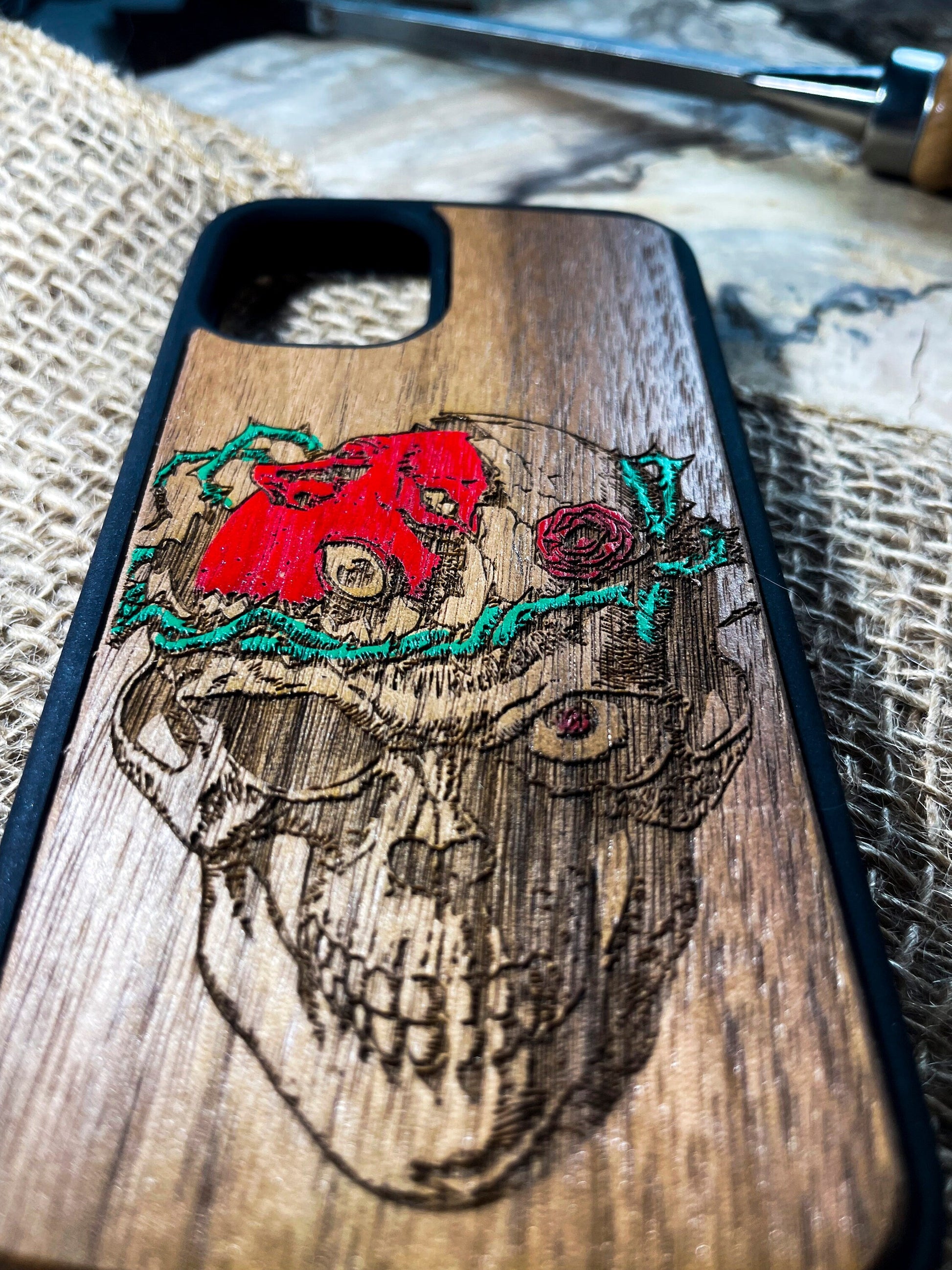 a wooden phone case with a picture of a skull on it