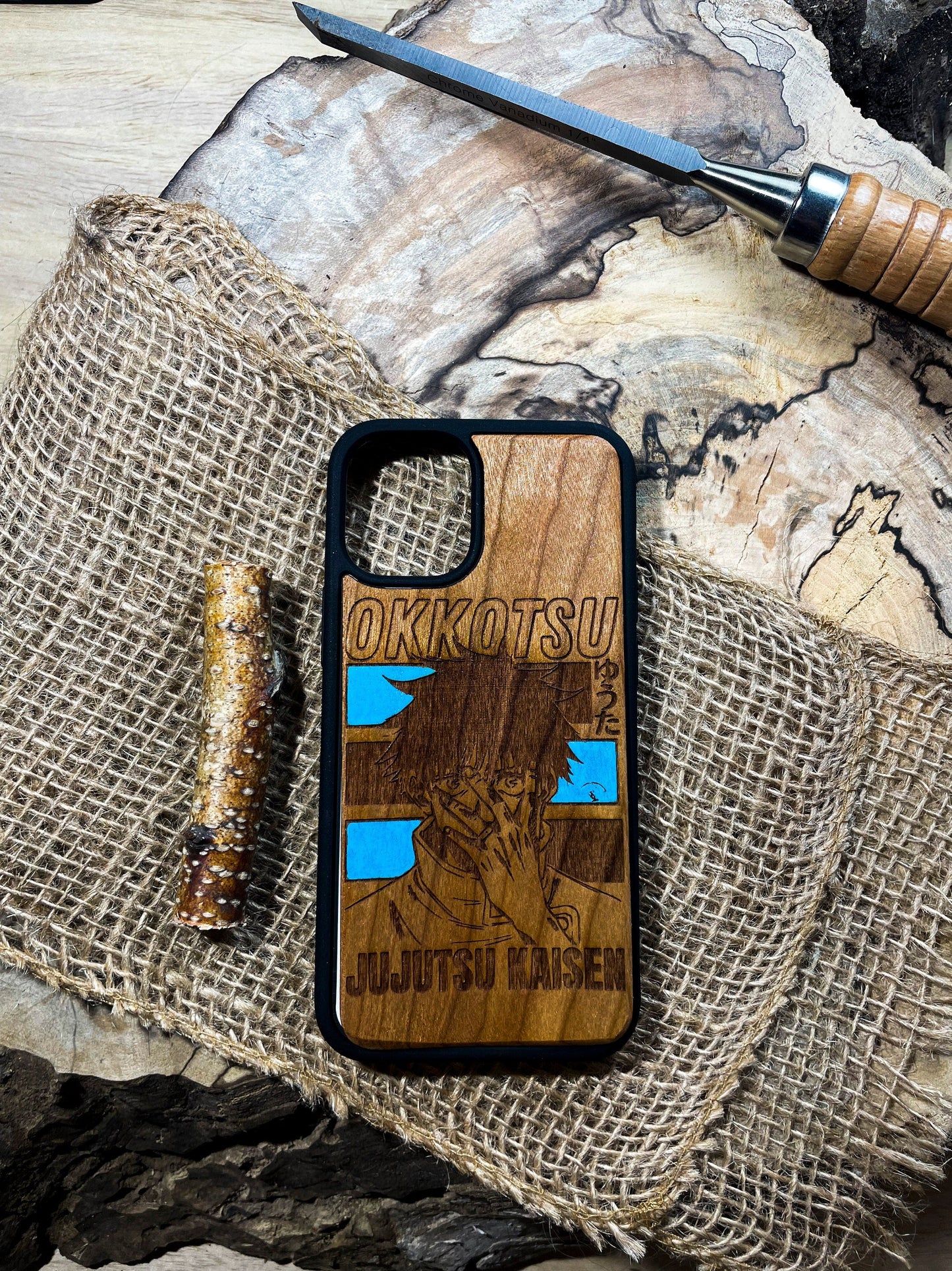 a wooden phone case sitting on top of a piece of wood