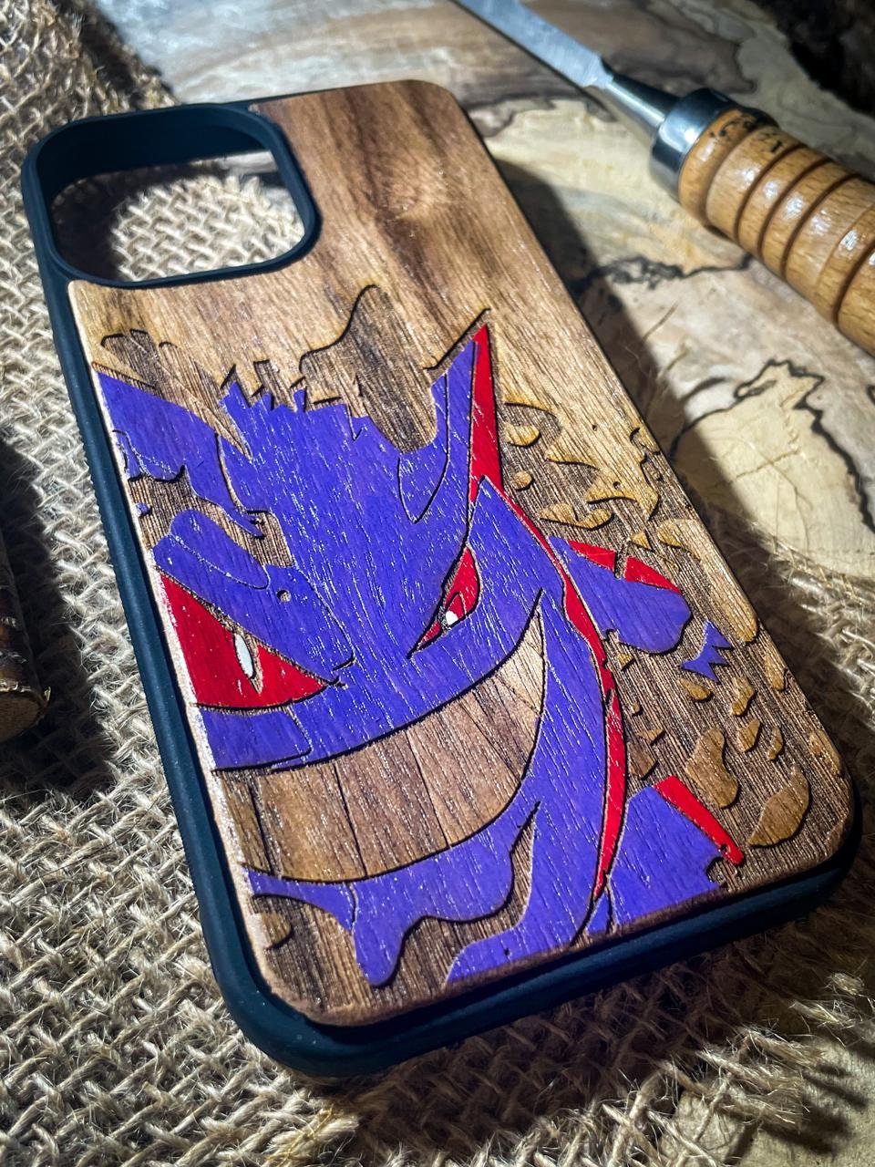 a wooden phone case with a picture of a dragon on it