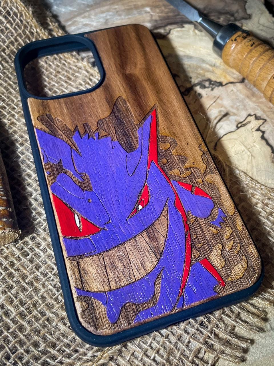 a wooden phone case with a picture of a dragon on it