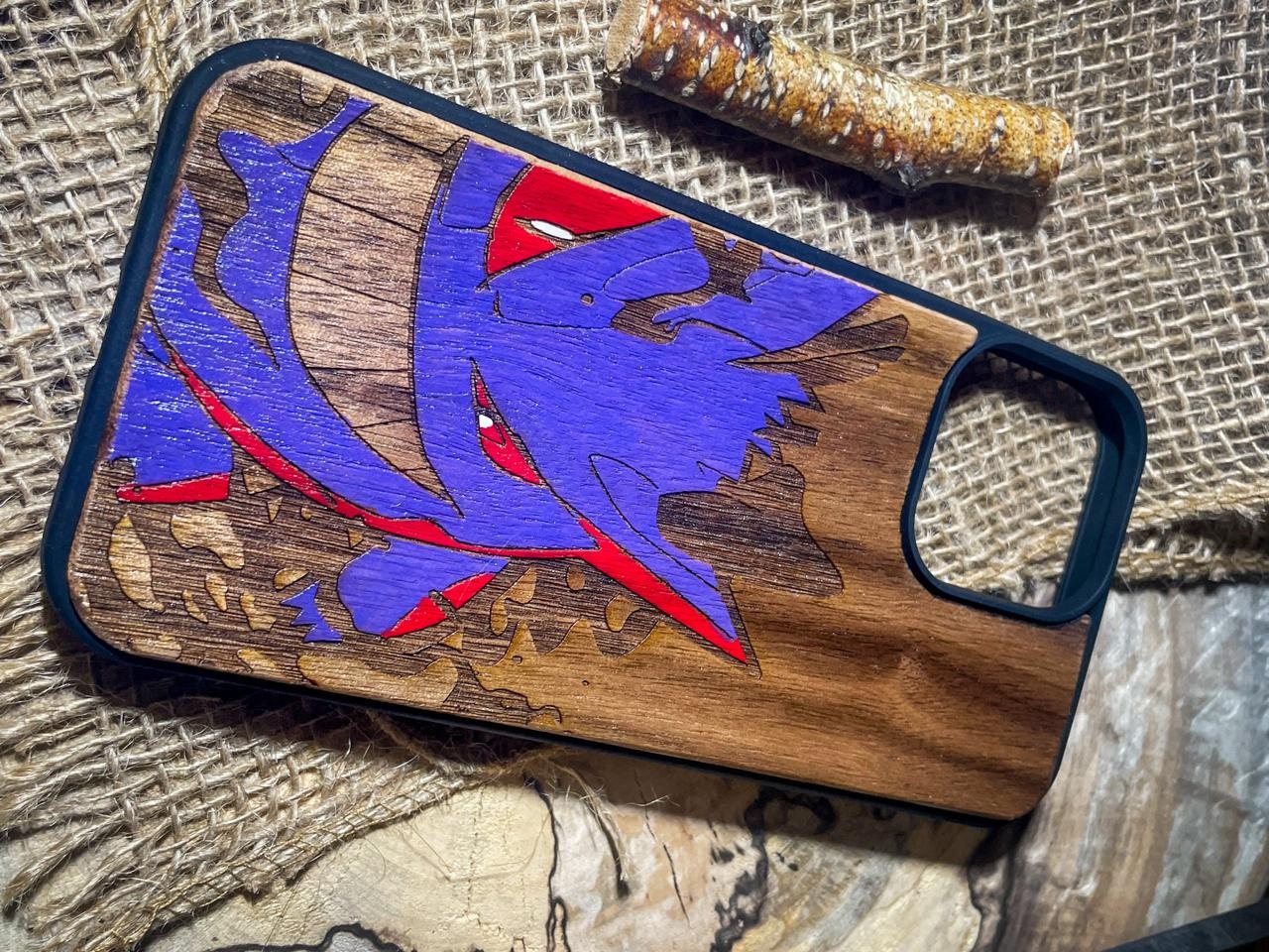 a wooden phone case with a picture of a fish on it