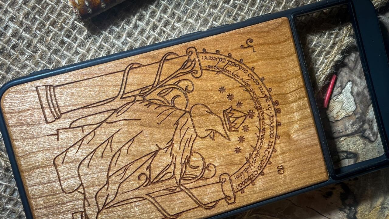 a wooden phone case with a picture of a wolf on it