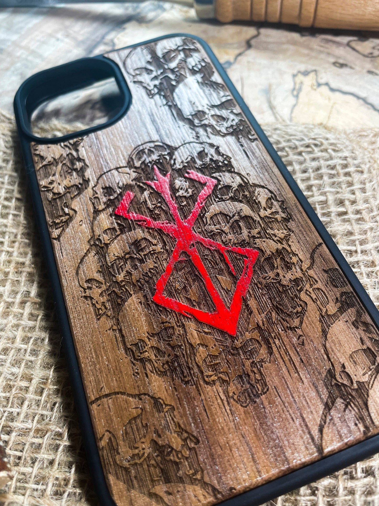 a wooden phone case with a red design on it