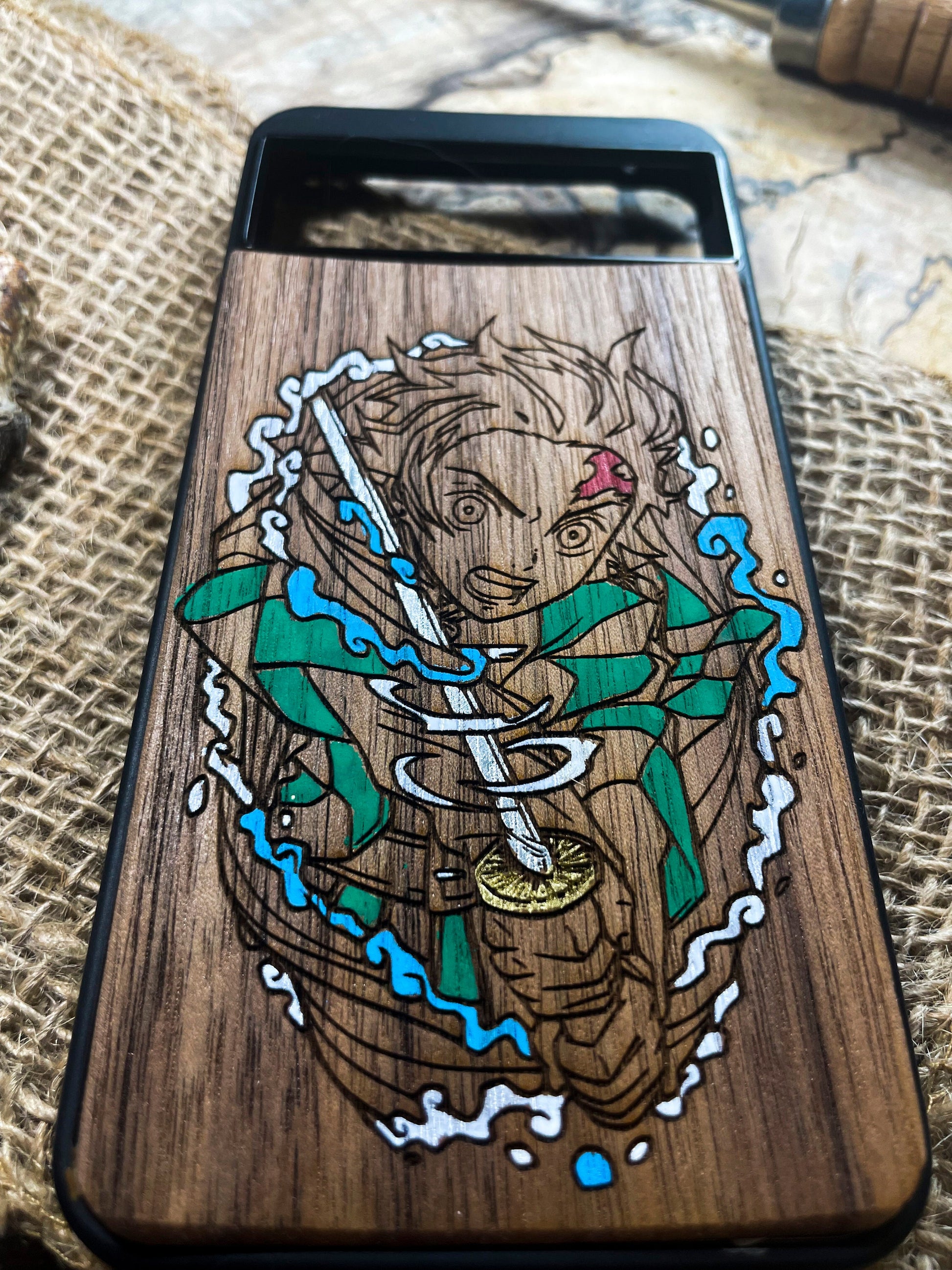 a wooden phone case with a picture of a woman holding a sword