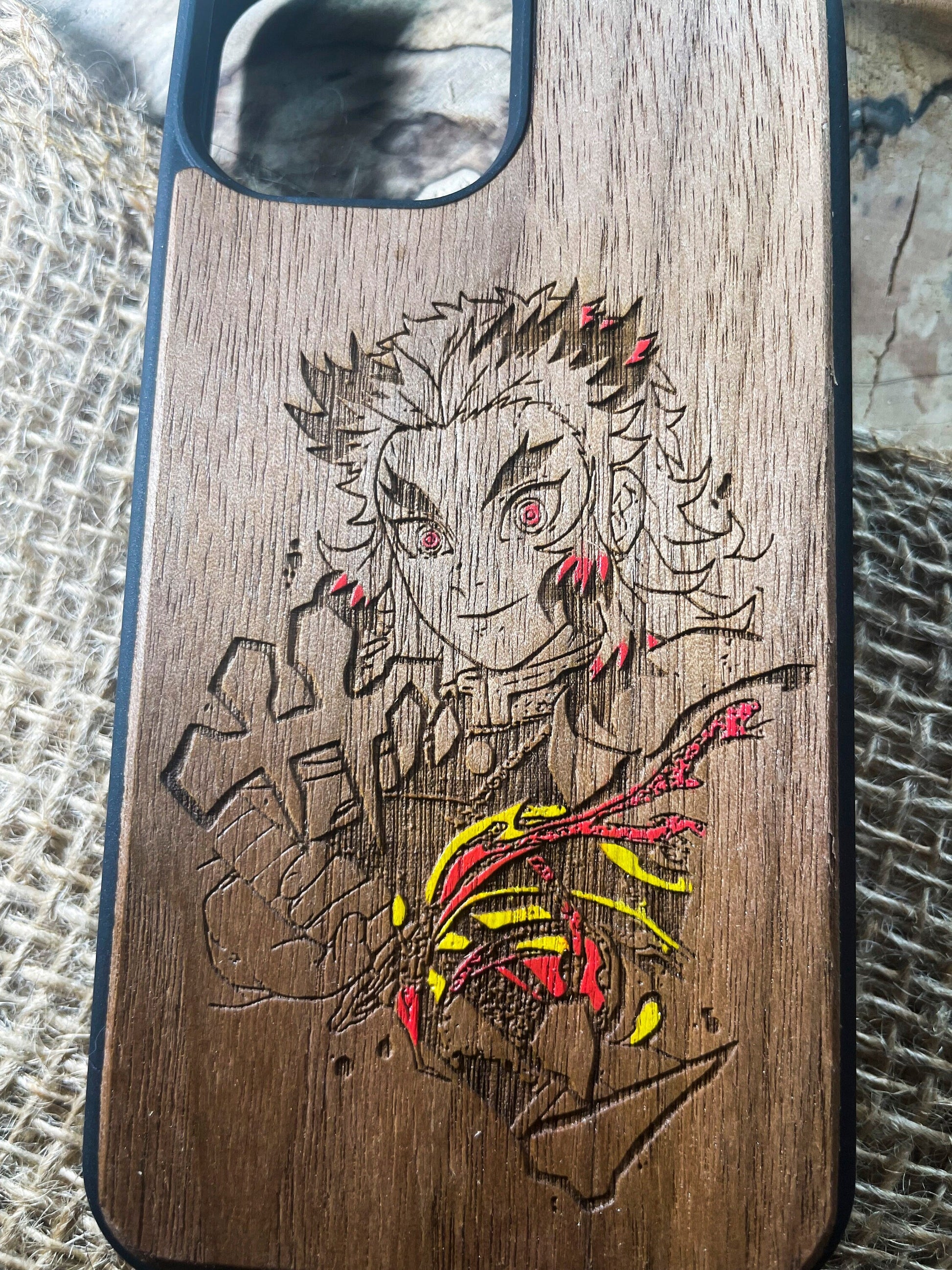 a wooden phone case with a drawing of a person on it