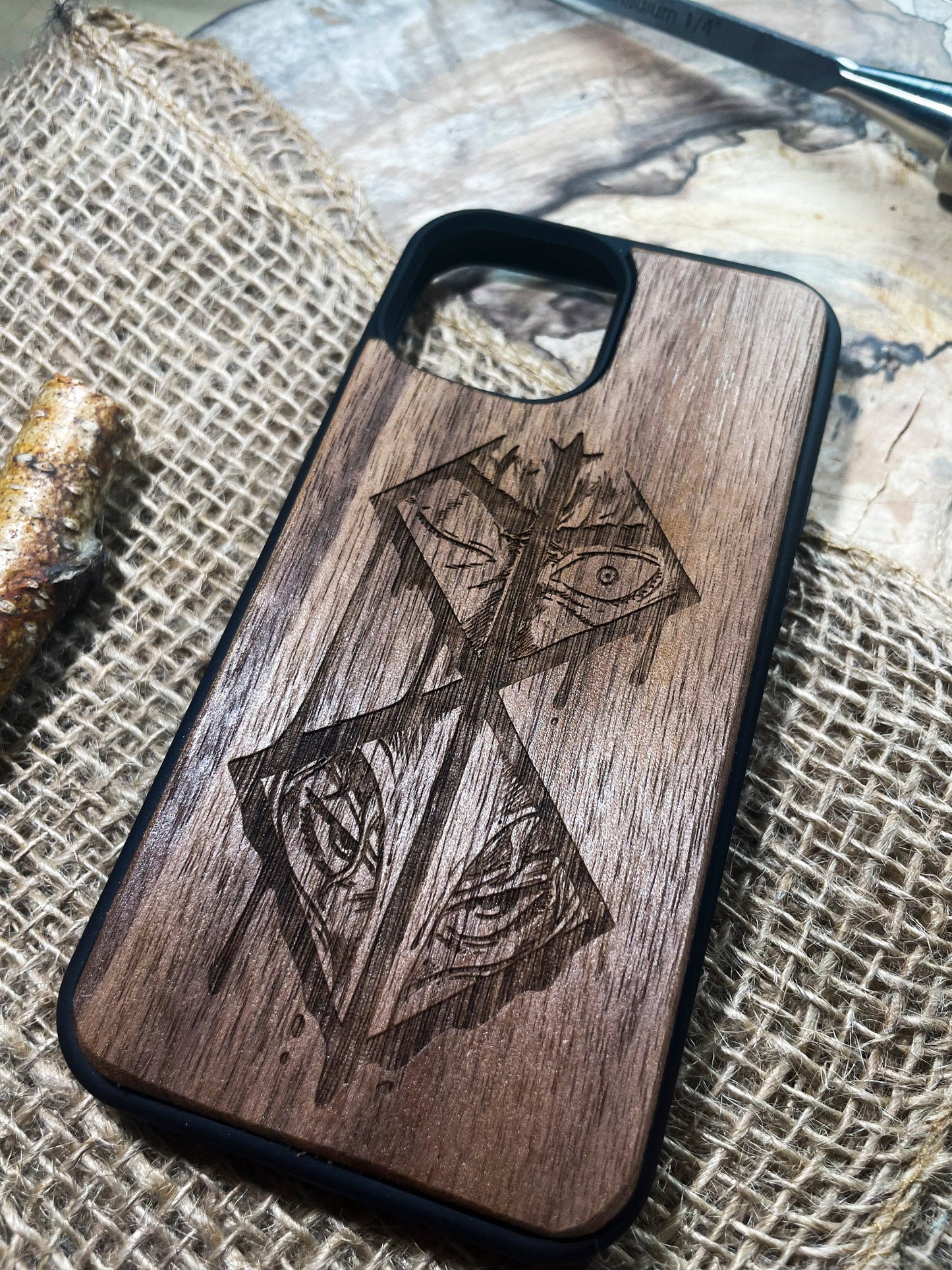 a wooden phone case with a picture of a cross on it