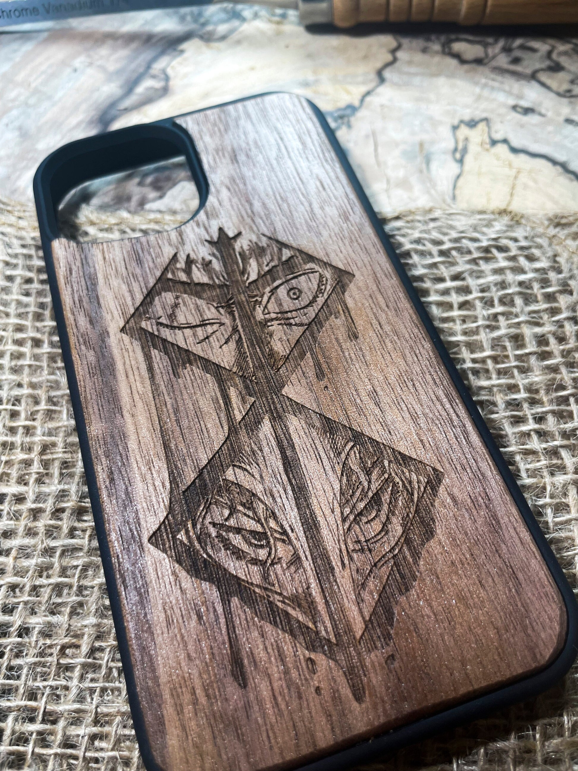 a wooden phone case with a picture of a cross on it