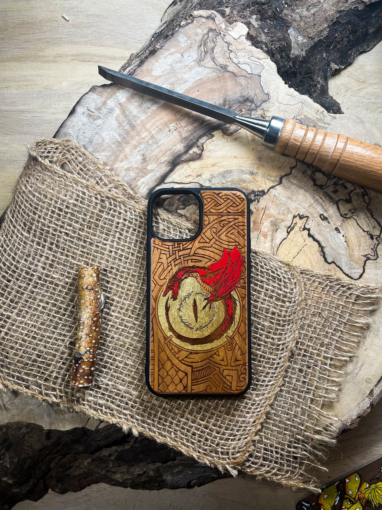 a wooden phone case with a red dragon on it