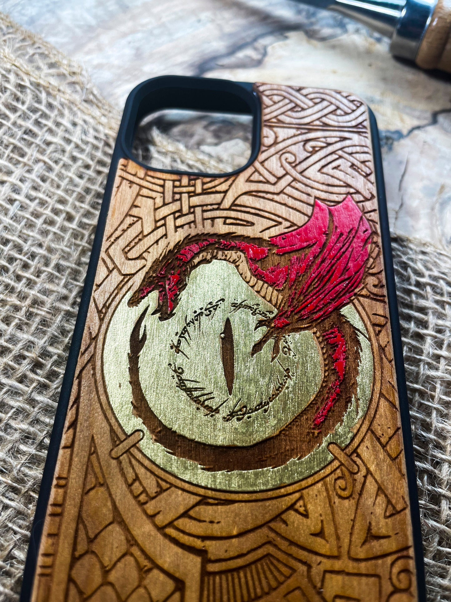 a wooden phone case with a picture of a dragon on it