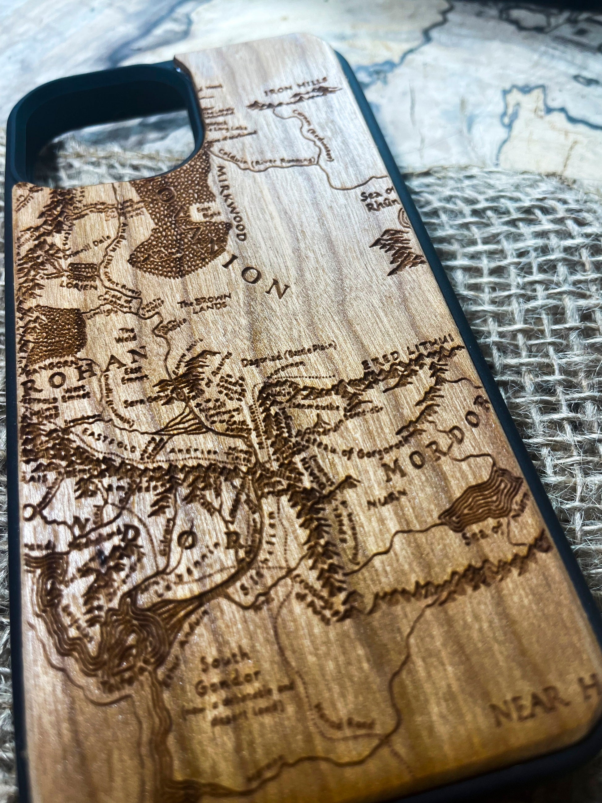 a wooden phone case with a map of the world on it