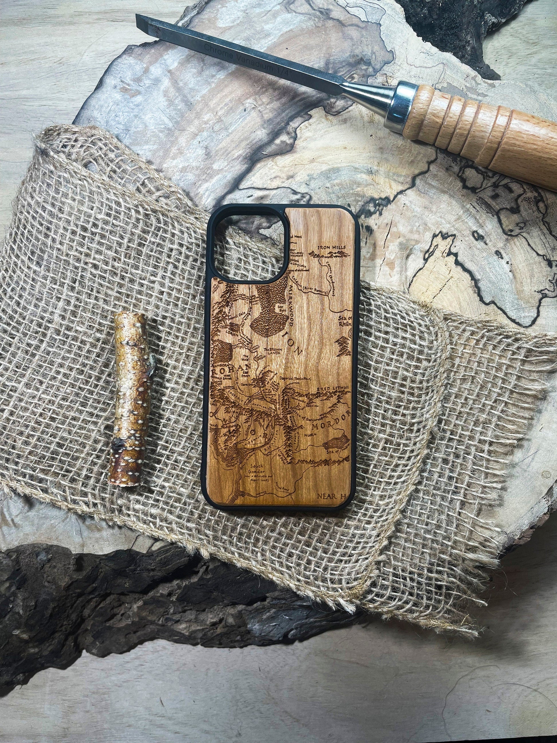 a wooden phone case sitting on top of a piece of wood