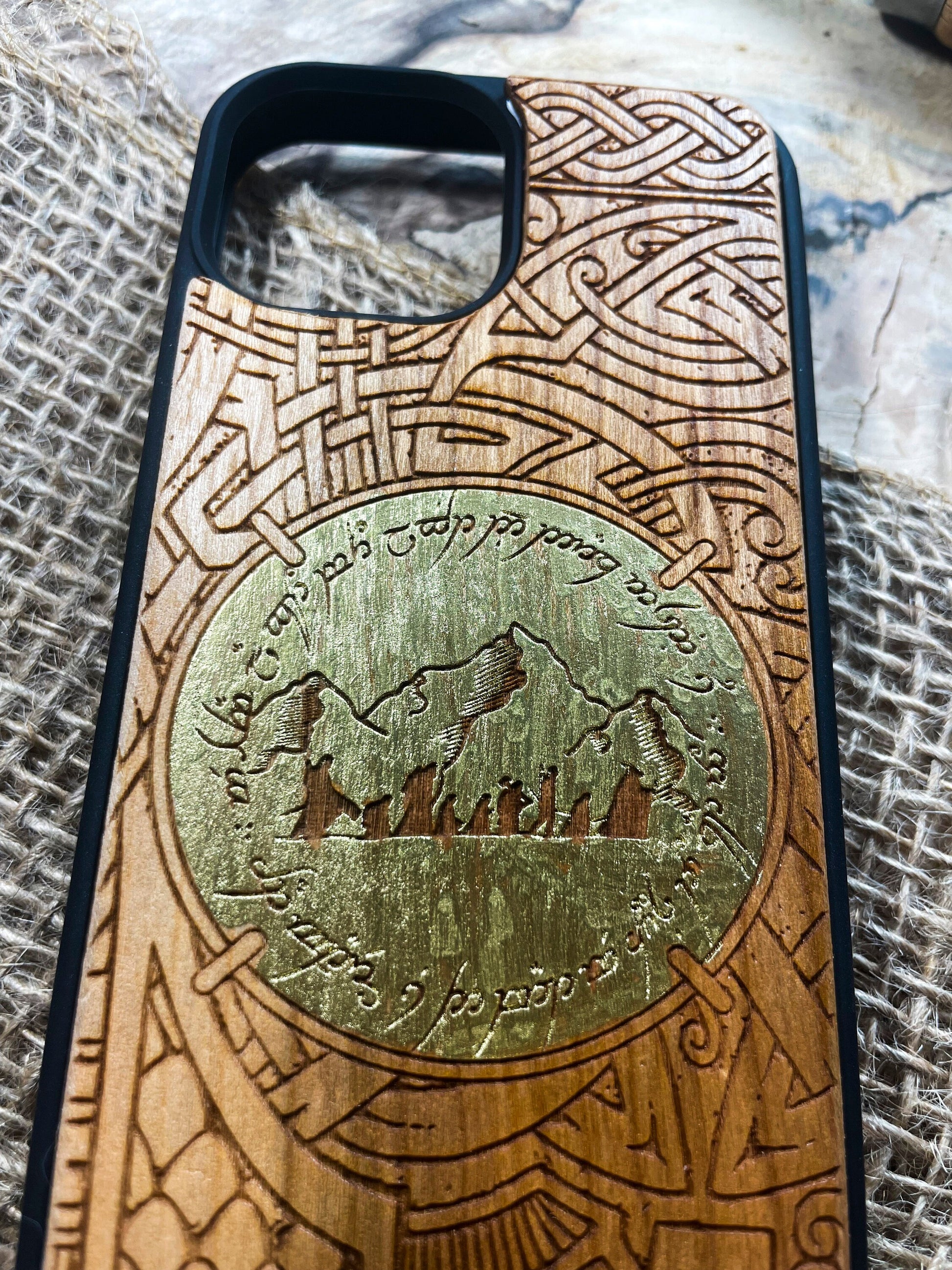 a wooden phone case with a carved design on it