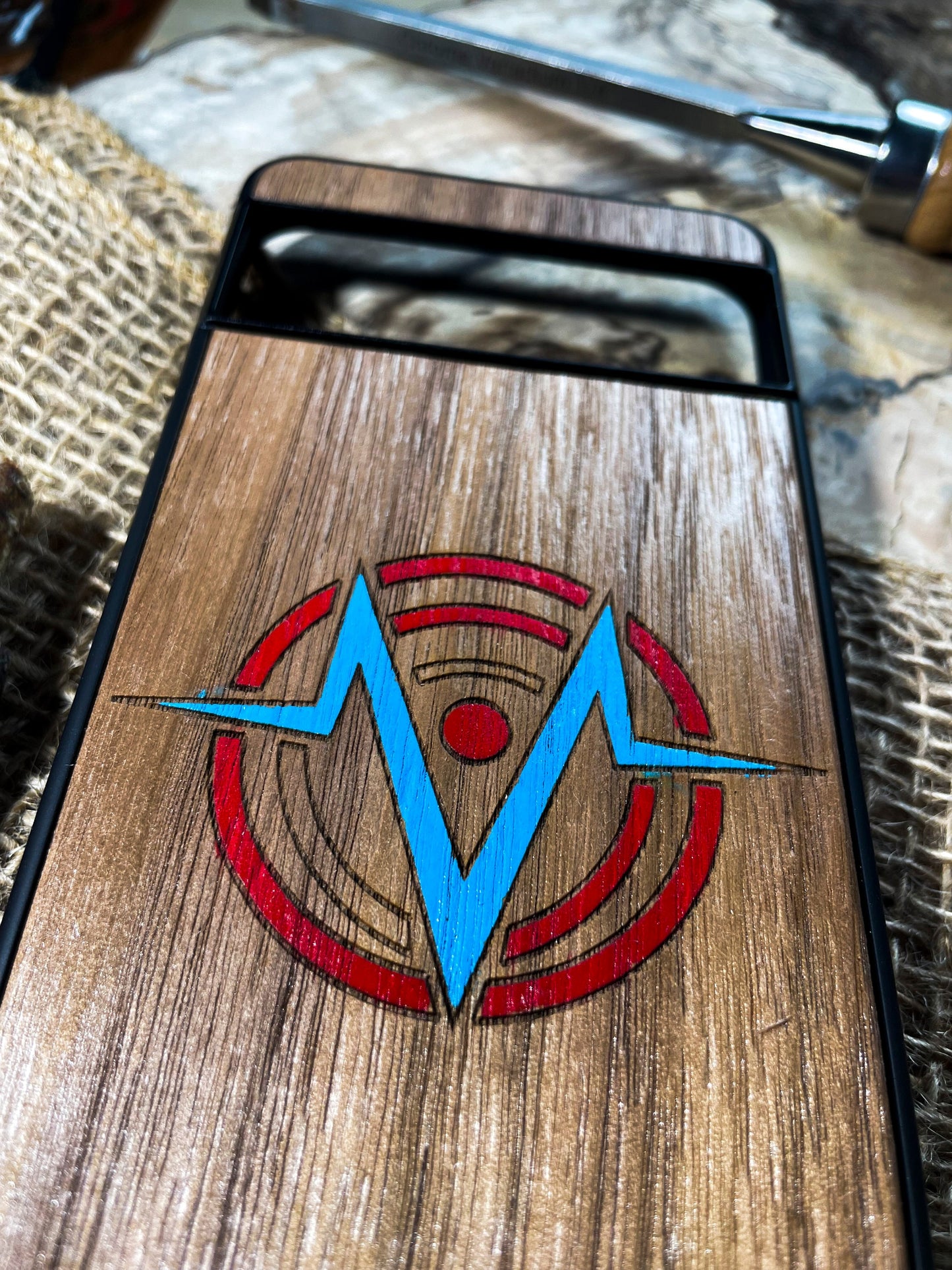 a wooden case with a blue and red logo on it